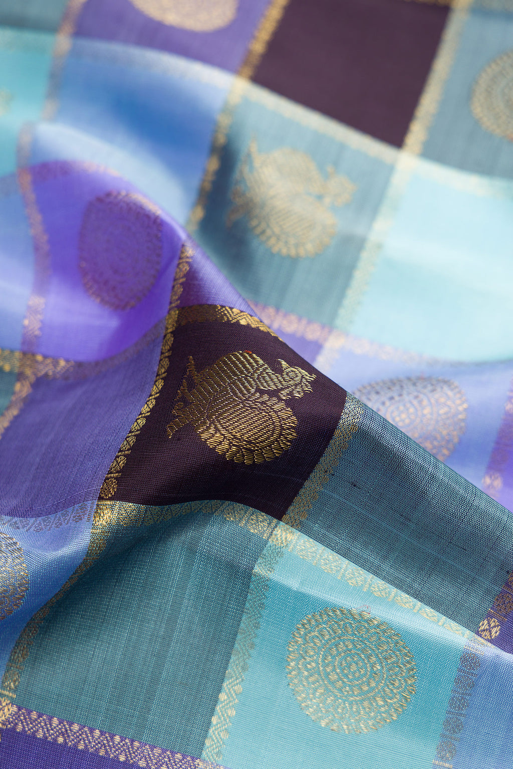 Close up of Pure Silk Pure Zari Multi Color Kanjivaram Saree with Checked design on the body and Zari Border.  displaying folds