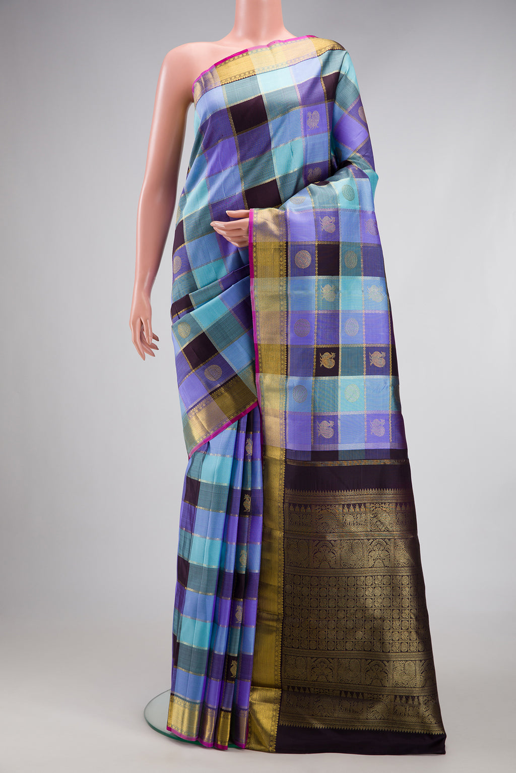 Pure Silk Pure Zari Multi Color Kanjivaram Saree with Checked design on the body and Zari Border.  displayed on a mannequin