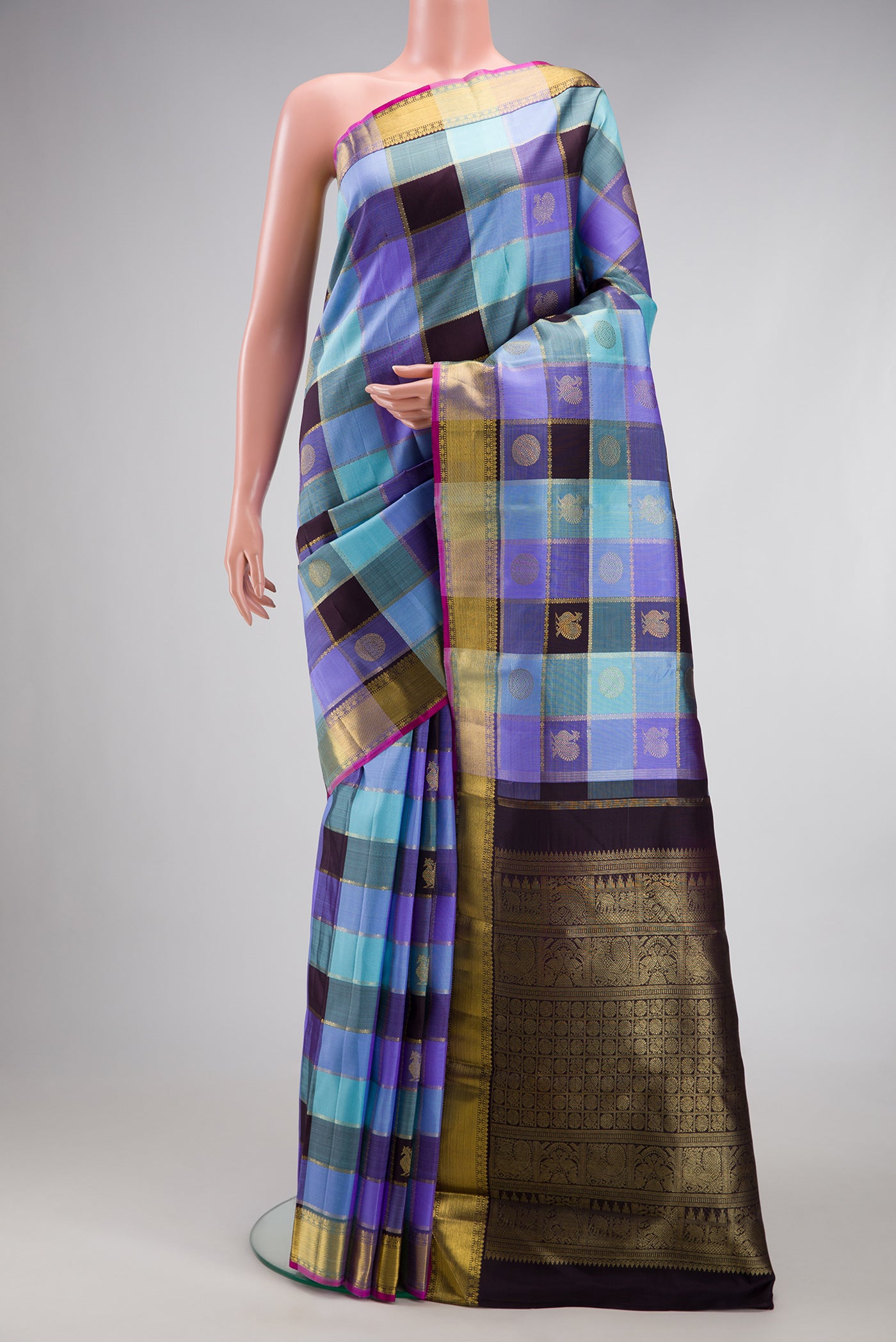 Pure Silk Pure Zari Multi Color Kanjivaram Saree with Checked design on the body and Zari Border.  displayed on a mannequin