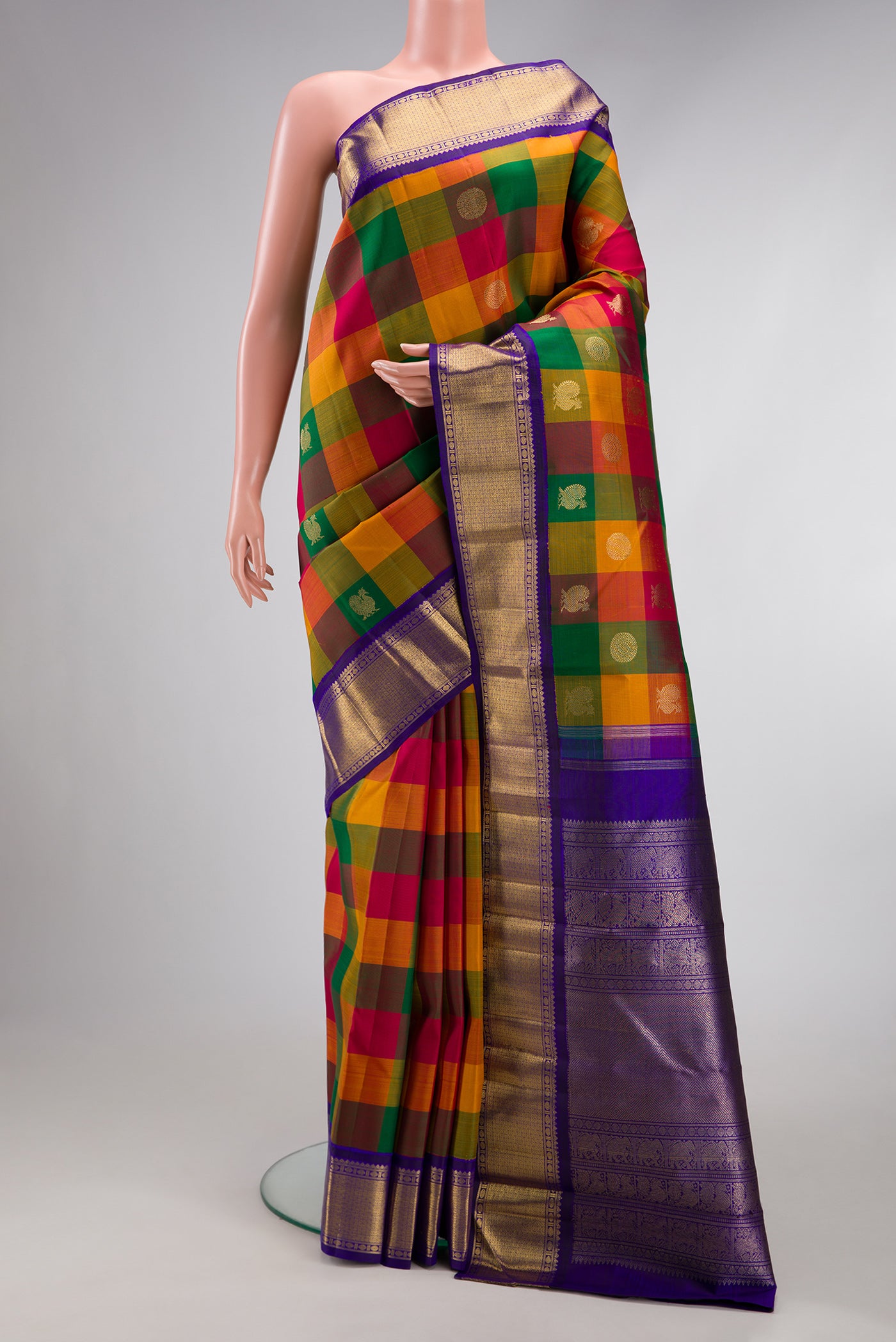 Pure Silk Pure Zari Multi Color Kanjivaram Saree with Checked design on the body and Zari Border.  displayed on a mannequin