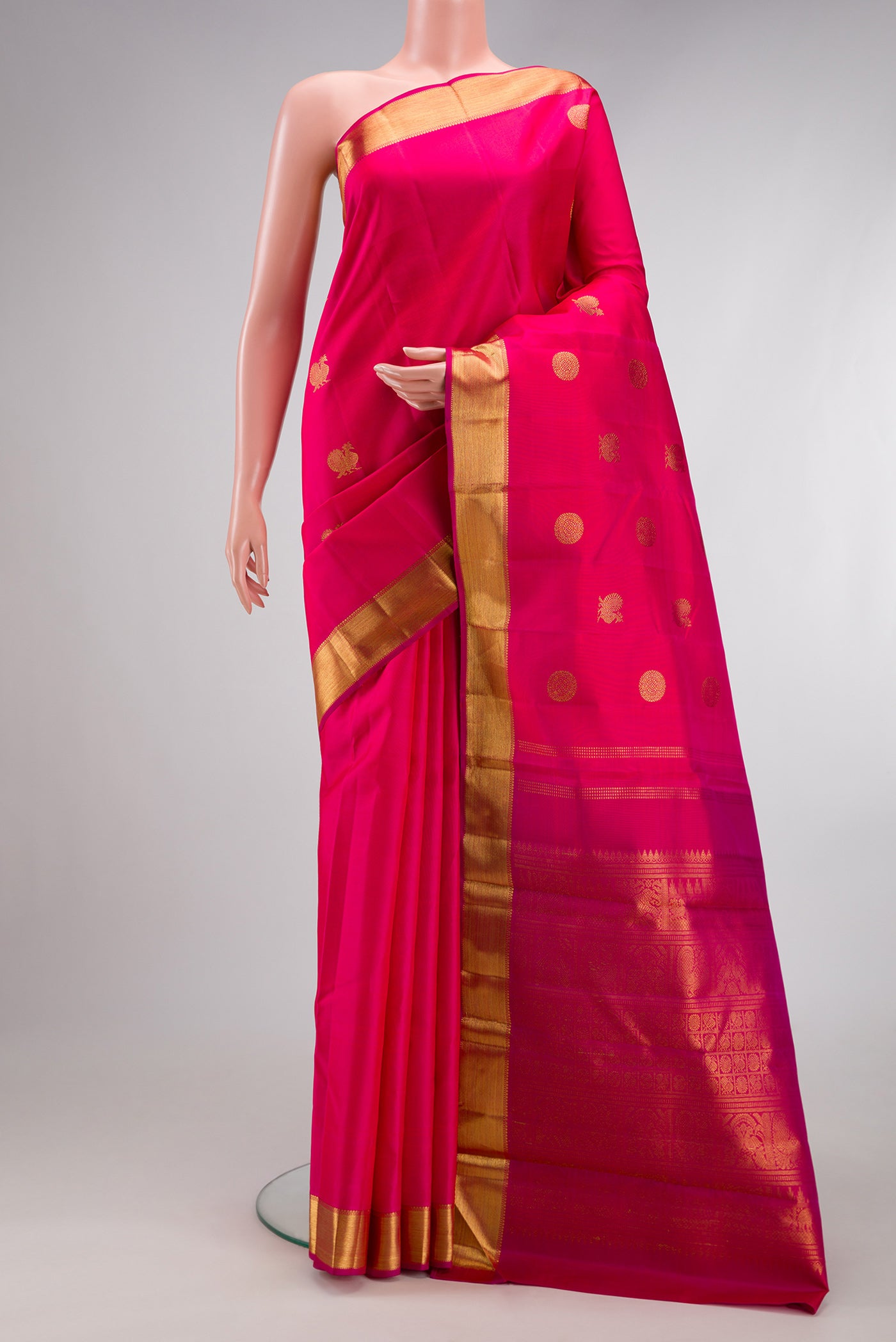 Pure Silk Pure Zari Pink Kanchipuram Saree with Zari Butta on the body and Zari Border.  displayed on a mannequin