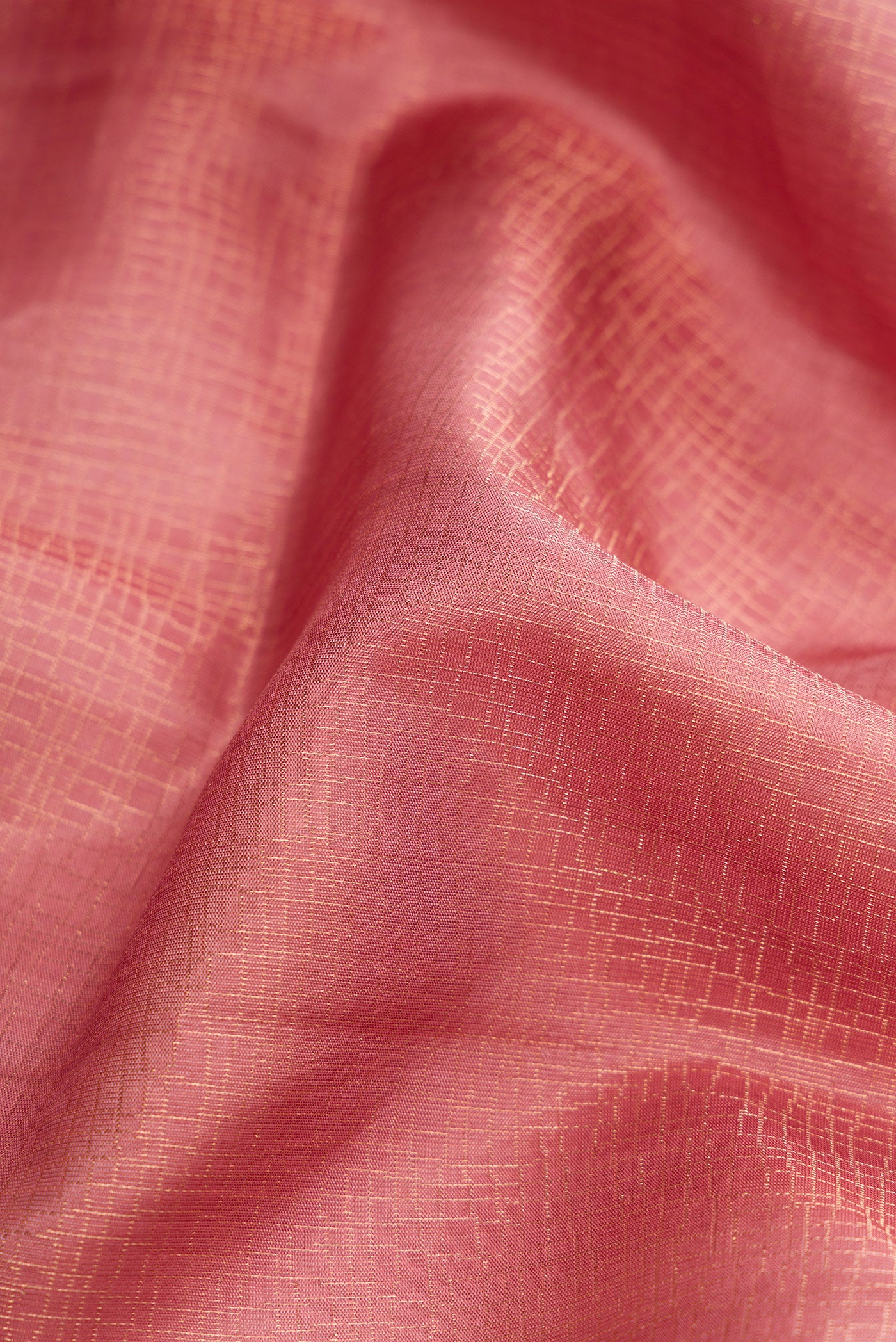 Close up of Rose Gold Dual Tone Soft Silk Saree with Zari Brocade on the body and Zari Border.  displaying folds