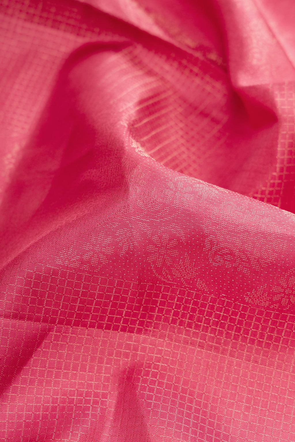 Close up of Pink Dual Tone Soft Silk Saree with Zari Butta on the body and Zari Border.  displaying folds