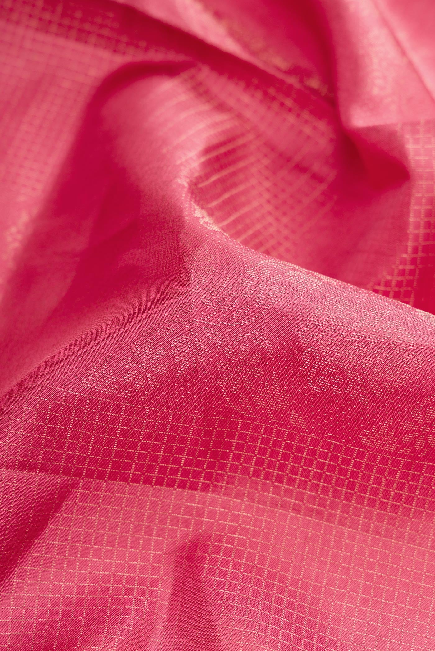 Close up of Pink Dual Tone Soft Silk Saree with Zari Butta on the body and Zari Border.  displaying folds