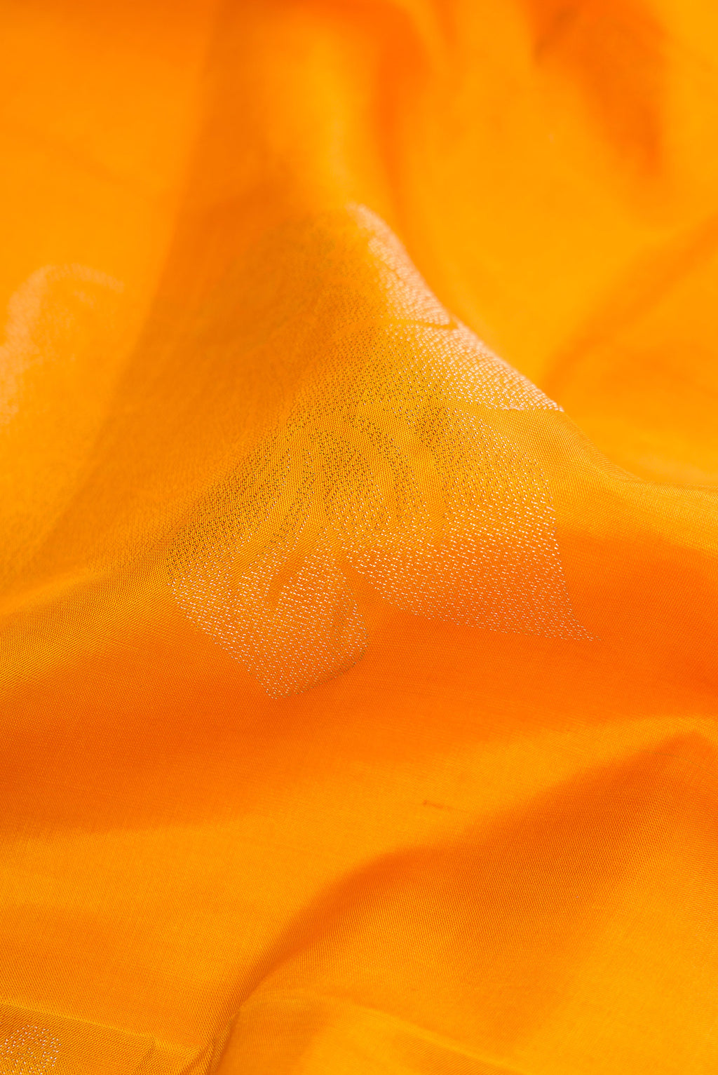 Close up of Mustard Dual Tone Soft Silk Saree with Zari Butta on the body and Fancy Border.  displaying folds