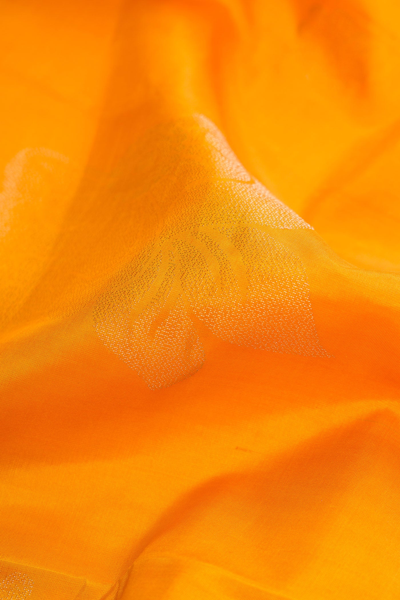 Close up of Mustard Dual Tone Soft Silk Saree with Zari Butta on the body and Fancy Border.  displaying folds