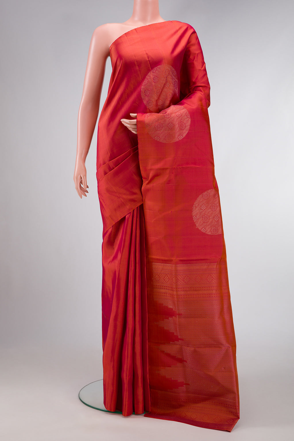 Brick Orange Dual Tone Soft Silk Saree with Zari Butta on the body and Without Border.  displayed on a mannequin