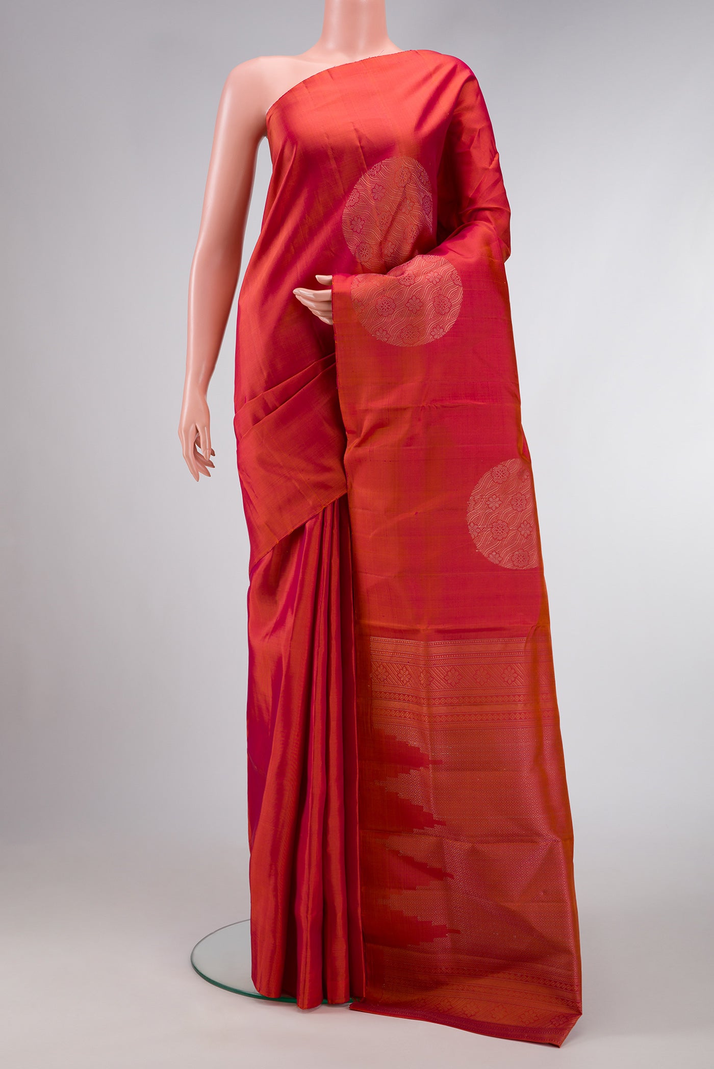 Brick Orange Dual Tone Soft Silk Saree with Zari Butta on the body and Without Border.  displayed on a mannequin