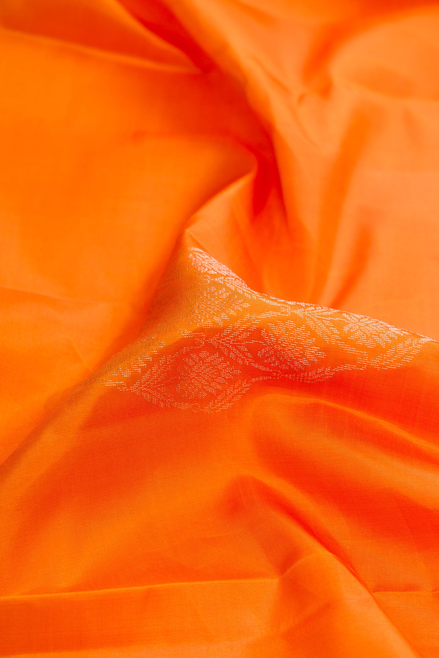 Close up of Mustard Dual Tone Soft Silk Saree with Zari Butta on the body and Fancy Border.  displaying folds
