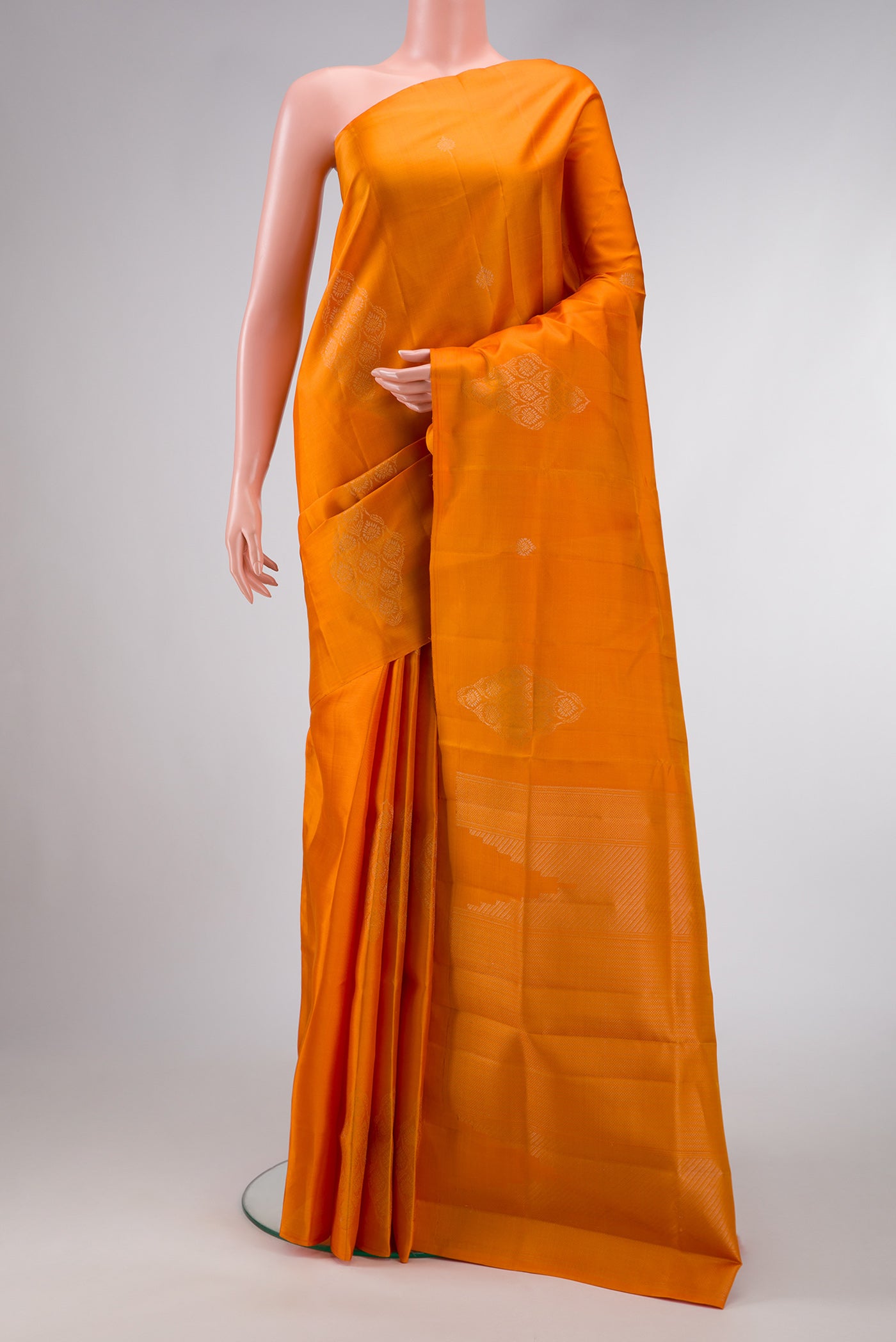 Mustard Dual Tone Soft Silk Saree with Zari Butta on the body and Fancy Border.  displayed on a mannequin