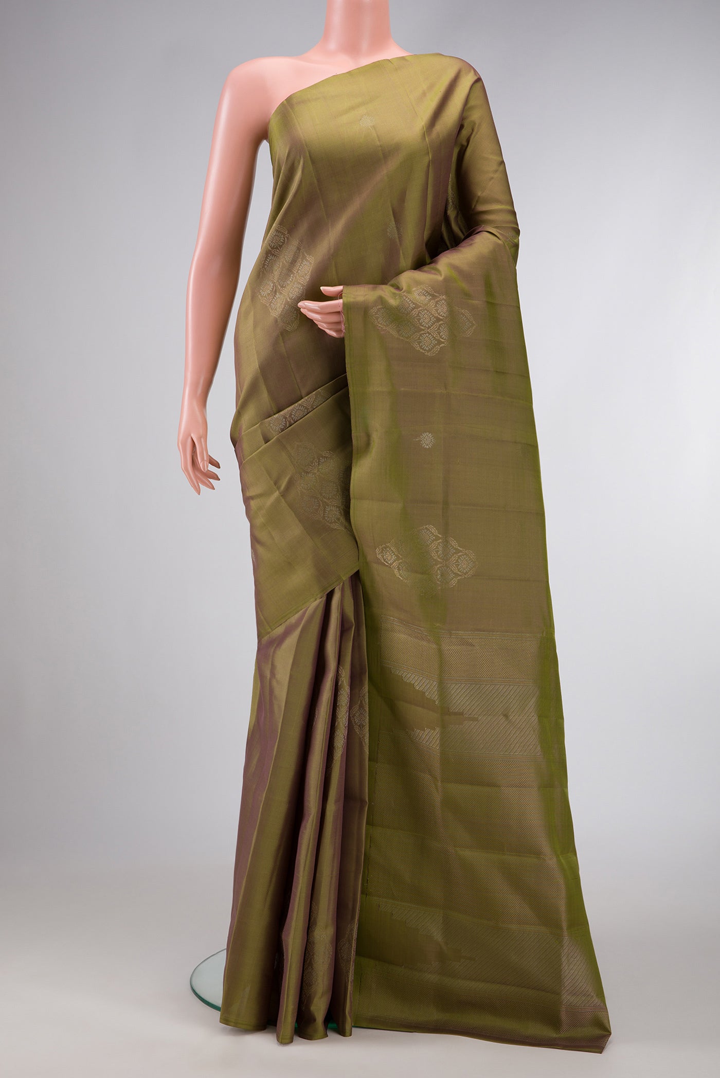 Green Dual Tone Soft Silk Saree with Zari Butta on the body and Without Border.  displayed on a mannequin