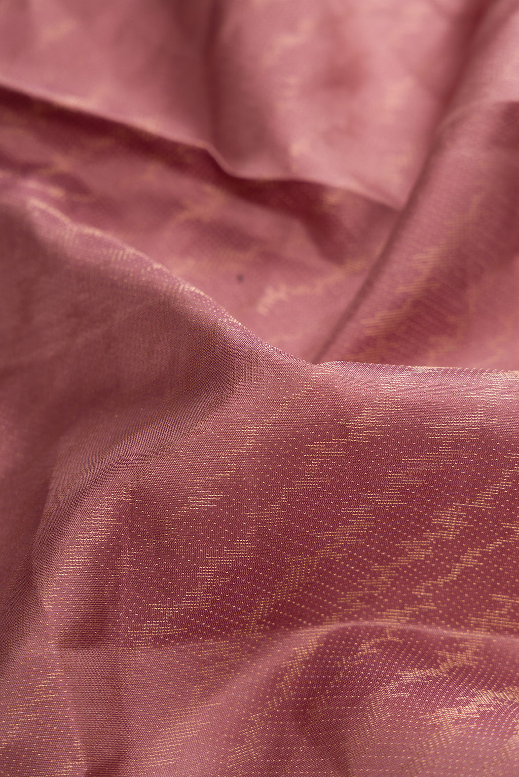 Close up of Rose Gold Dual Tone Soft Silk Saree with Zari Brocade on the body and Fancy Border.  displaying folds