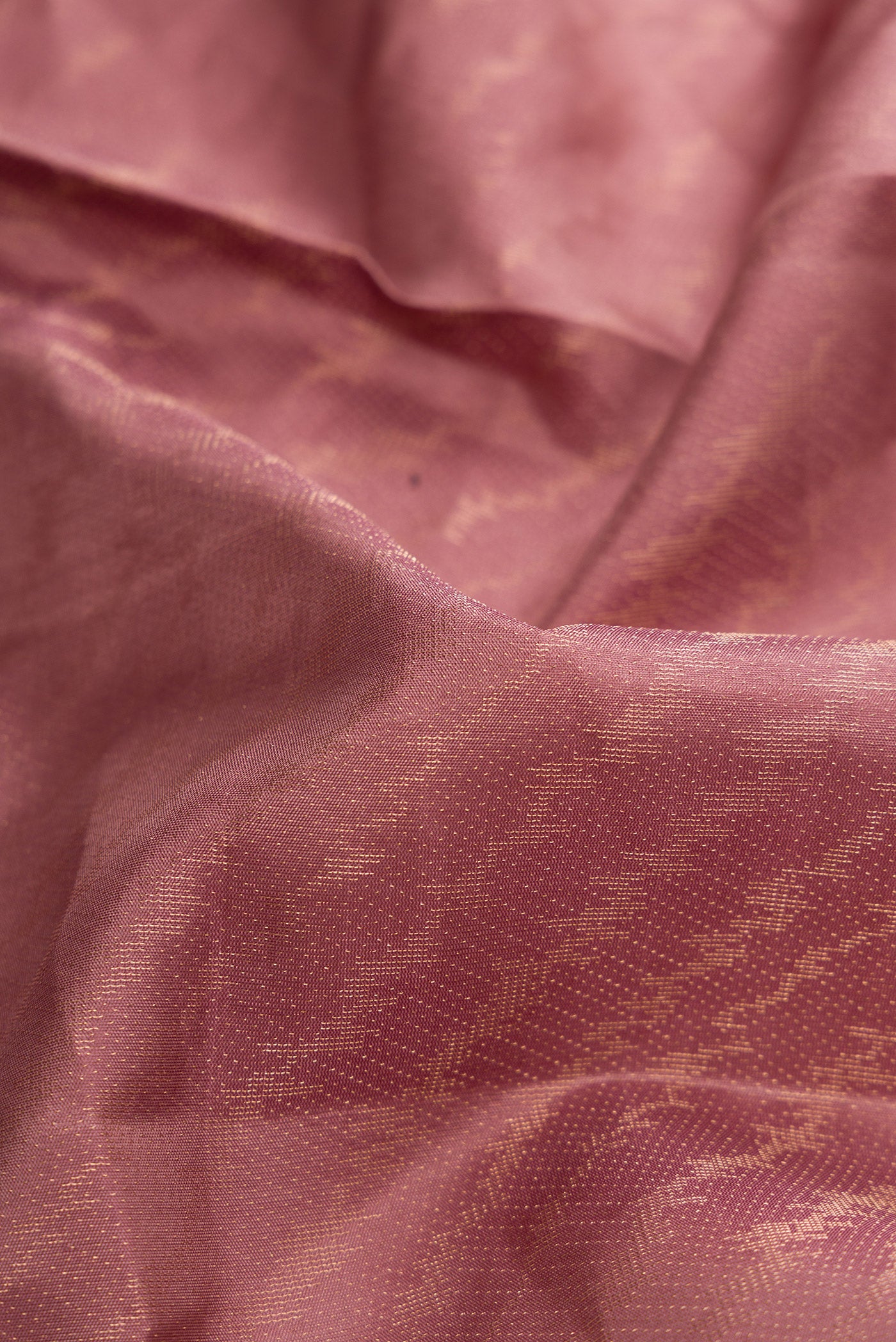 Close up of Rose Gold Dual Tone Soft Silk Saree with Zari Brocade on the body and Fancy Border.  displaying folds