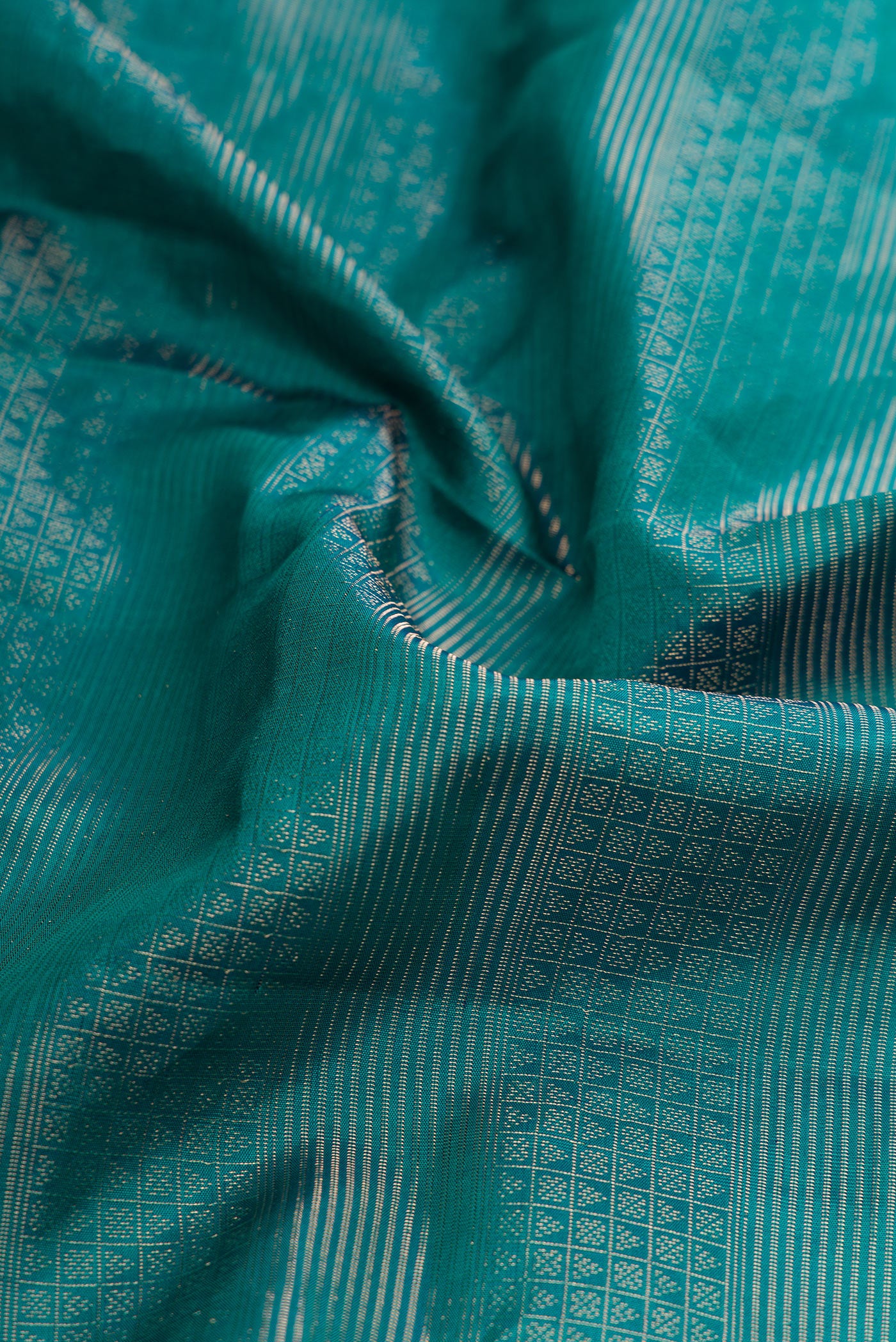 Close up of Imperial Red Dual Tone Soft Silk Saree with Zari Brocade on the body and Zari Border.  displaying folds
