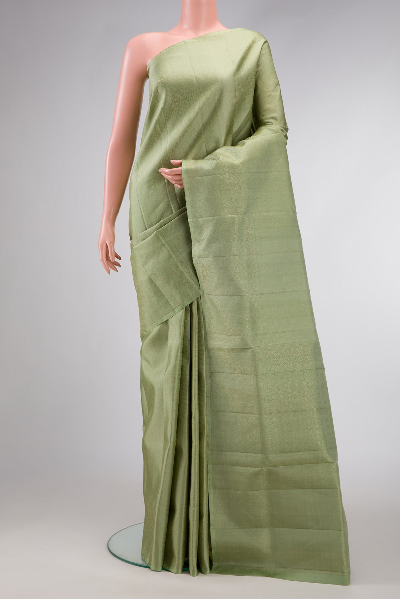 Pista Green Dual Tone Soft Silk Saree with Zari Brocade on the body and Fancy Border.  displayed on a mannequin