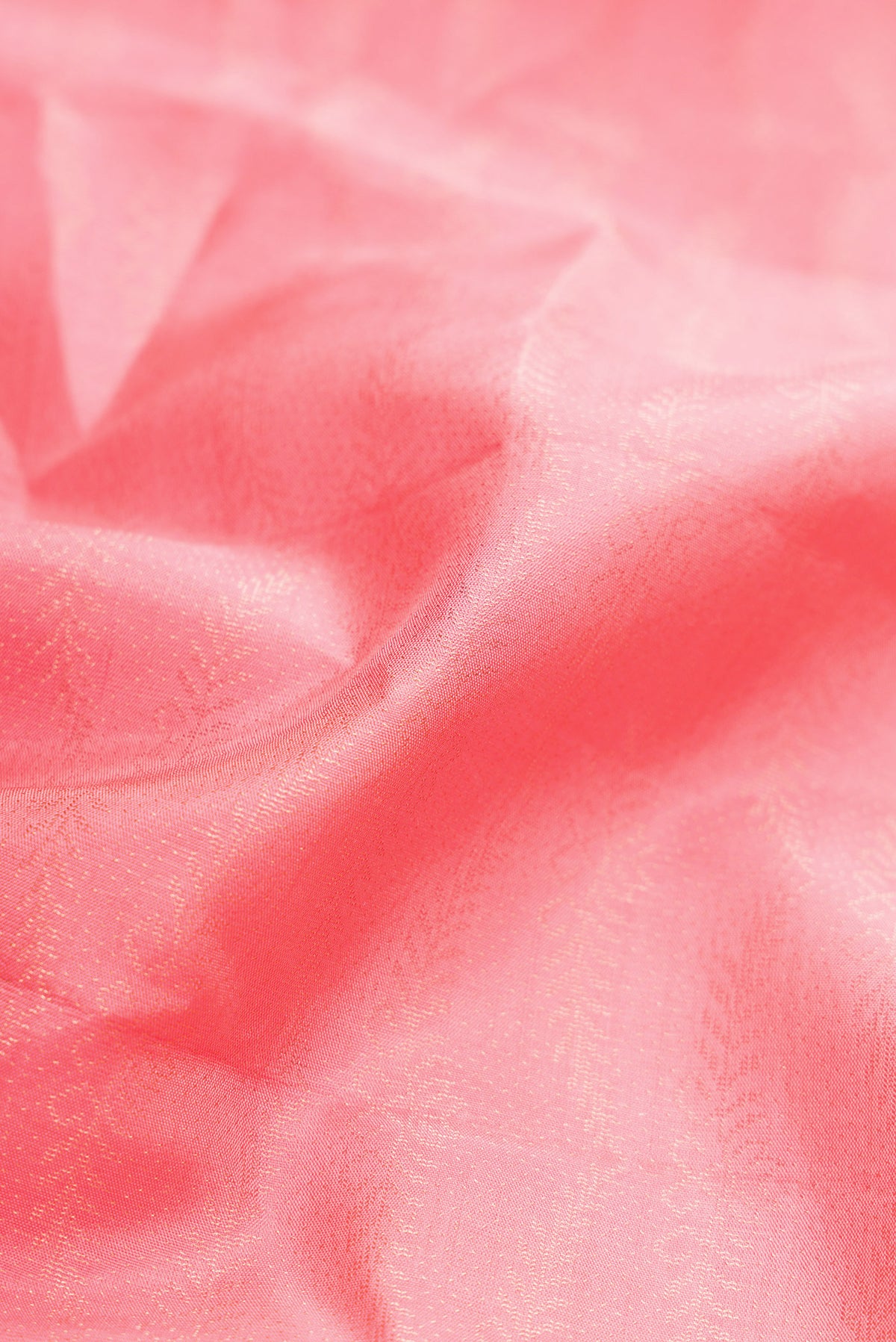 Close up of Peach Dual Tone Soft Silk Saree with Zari Brocade on the body and Fancy Border.  displaying folds