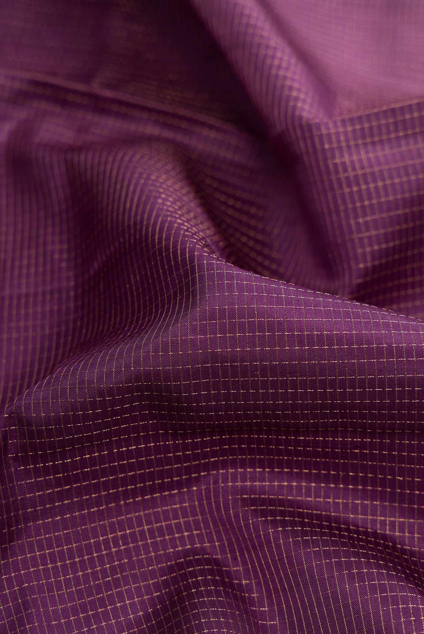 Close up of Purple Dual Tone Soft Silk Saree with Zari Brocade on the body and Fancy Border.  displaying folds