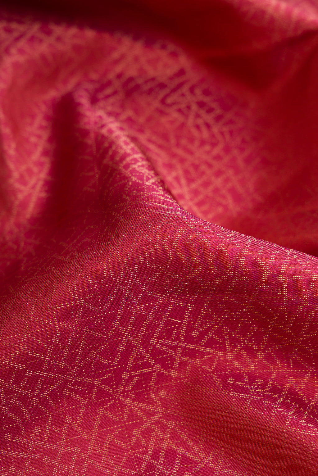 Close up of Brick Orange Dual Tone Soft Silk Saree with Zari Brocade on the body and Fancy Border.  displaying folds