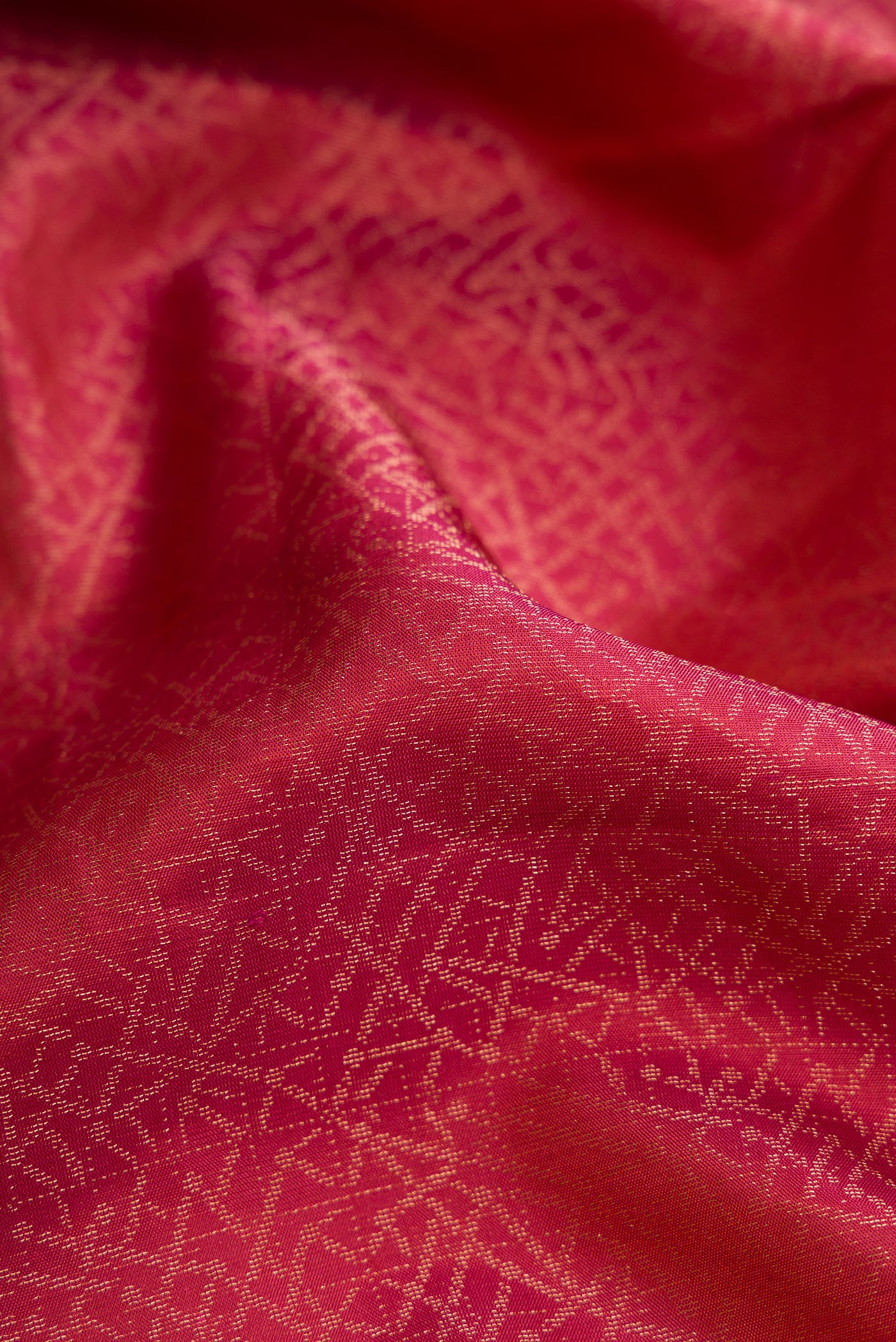 Close up of Brick Orange Dual Tone Soft Silk Saree with Zari Brocade on the body and Fancy Border.  displaying folds