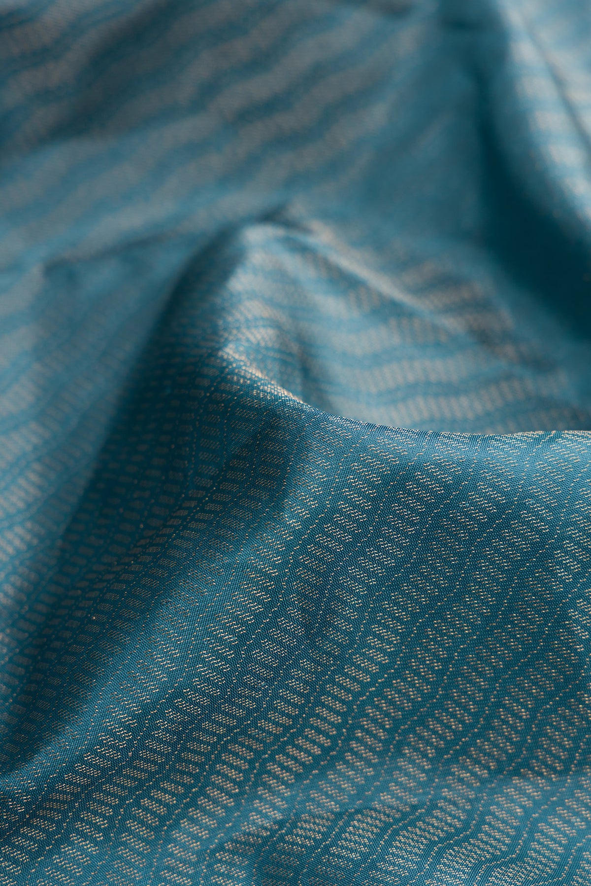 Close up of Maya Blue Dual Tone Soft Silk Saree with Zari Brocade on the body and Fancy Border.  displaying folds