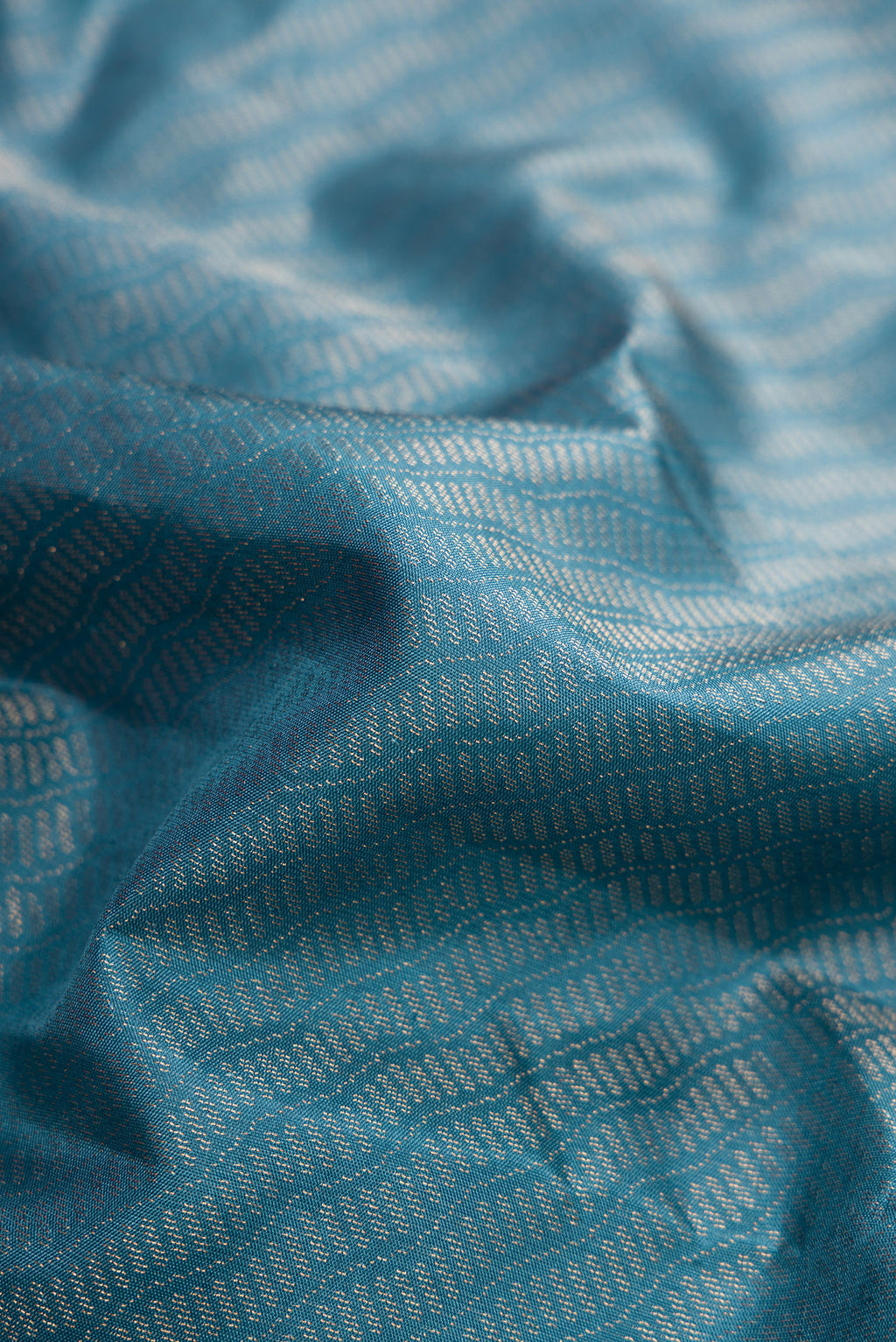 Close up of Maya Blue Dual Tone Soft Silk Saree with Zari Brocade on the body and Fancy Border.  displaying folds