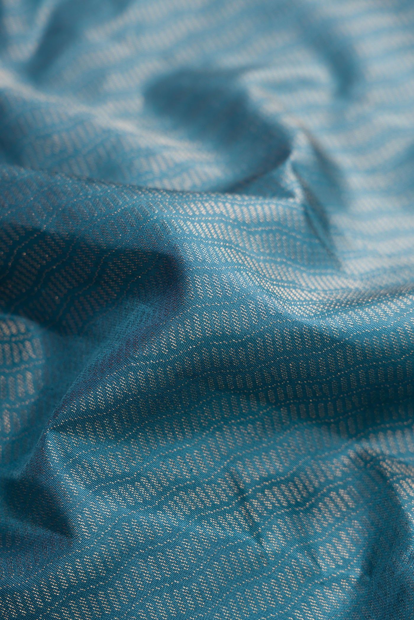 Close up of Maya Blue Dual Tone Soft Silk Saree with Zari Brocade on the body and Fancy Border.  displaying folds