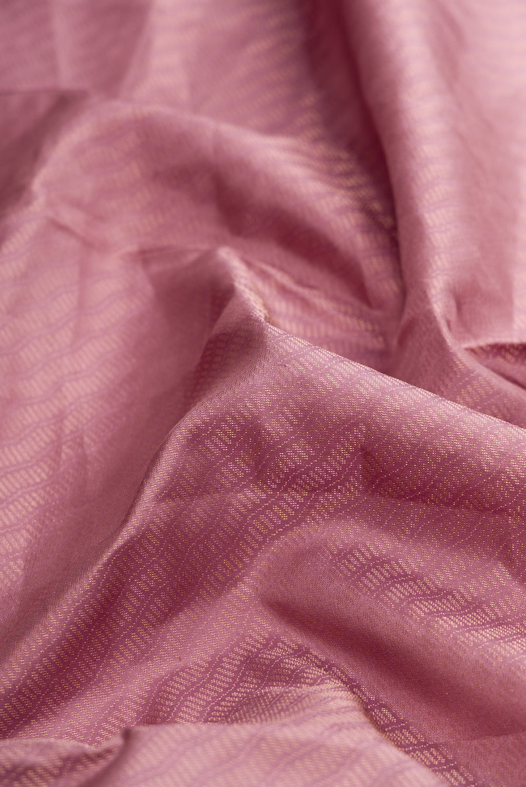 Close up of Rose Gold Dual Tone Soft Silk Saree with Zari Brocade on the body and Zari Border.  displaying folds