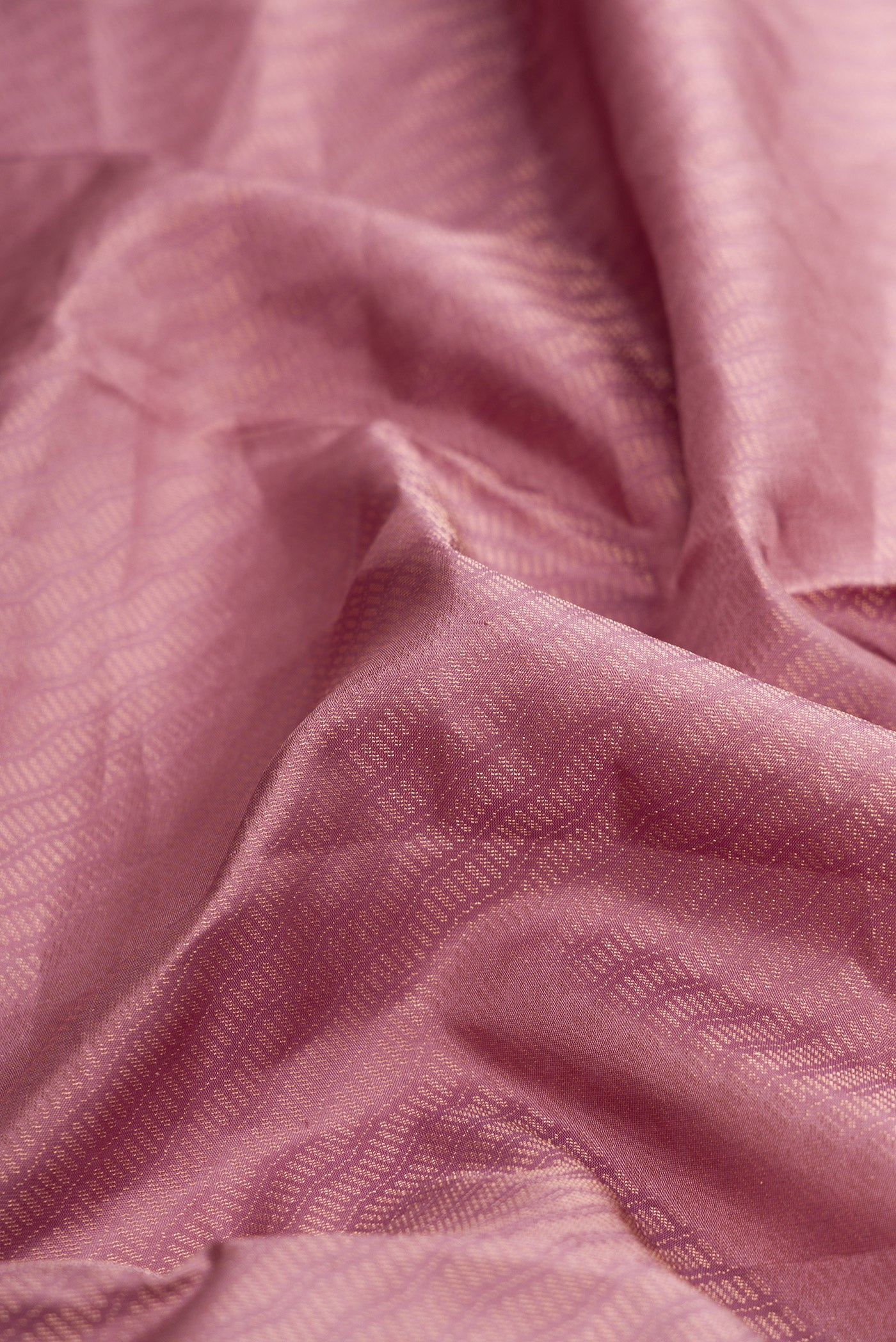 Close up of Rose Gold Dual Tone Soft Silk Saree with Zari Brocade on the body and Zari Border.  displaying folds