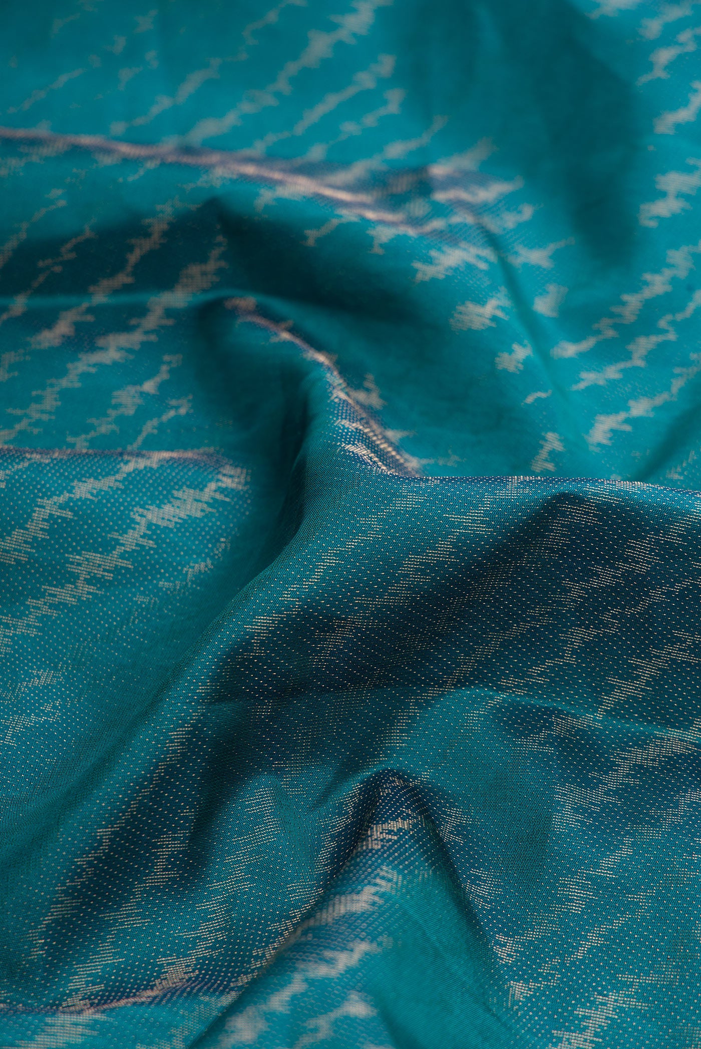 Close up of Peacock Blue Dual Tone Soft Silk Saree with Zari Brocade on the body and Zari Border.  displaying folds