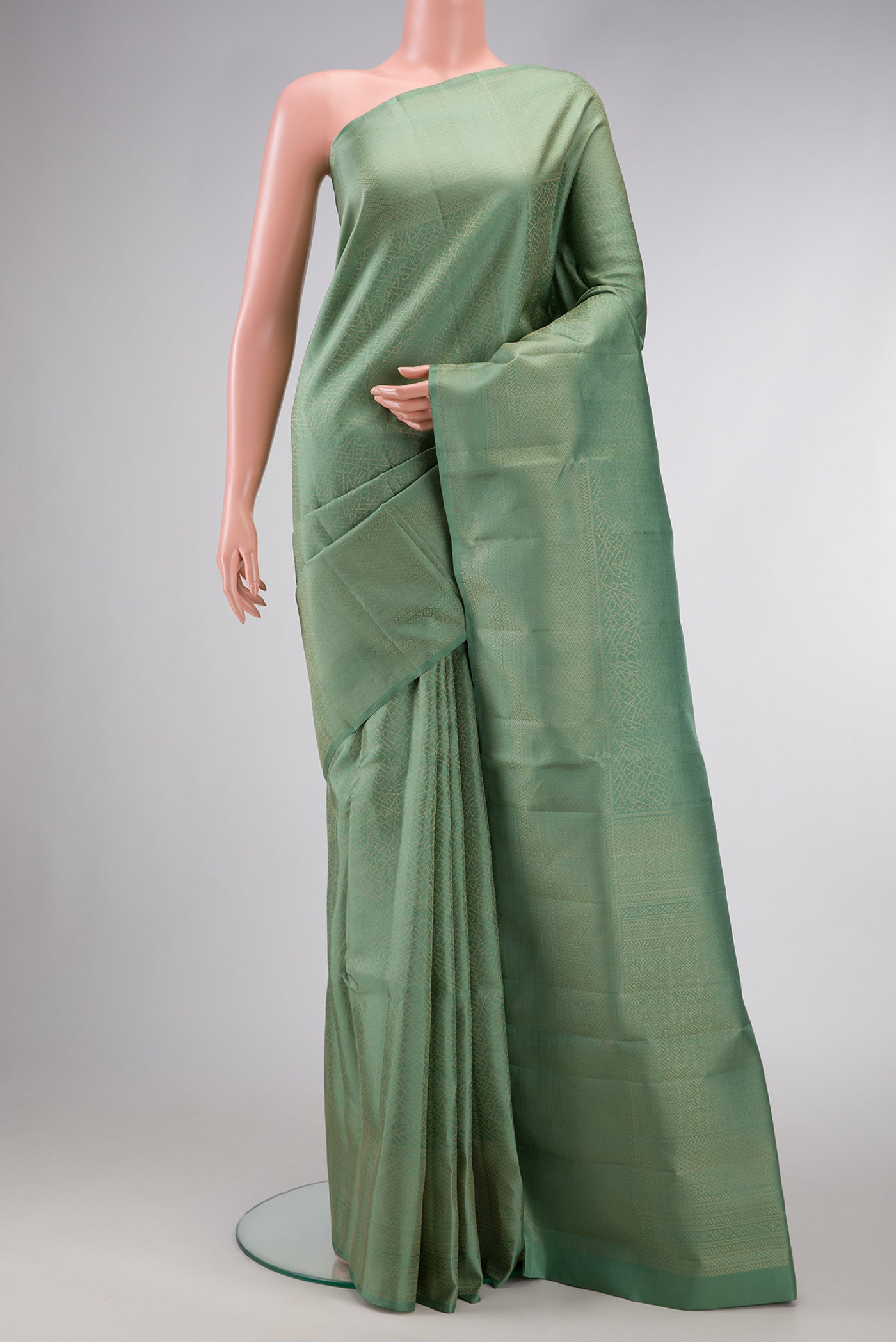 Pista Green Dual Tone Soft Silk Saree with Zari Brocade on the body and Fancy Border.  displayed on a mannequin