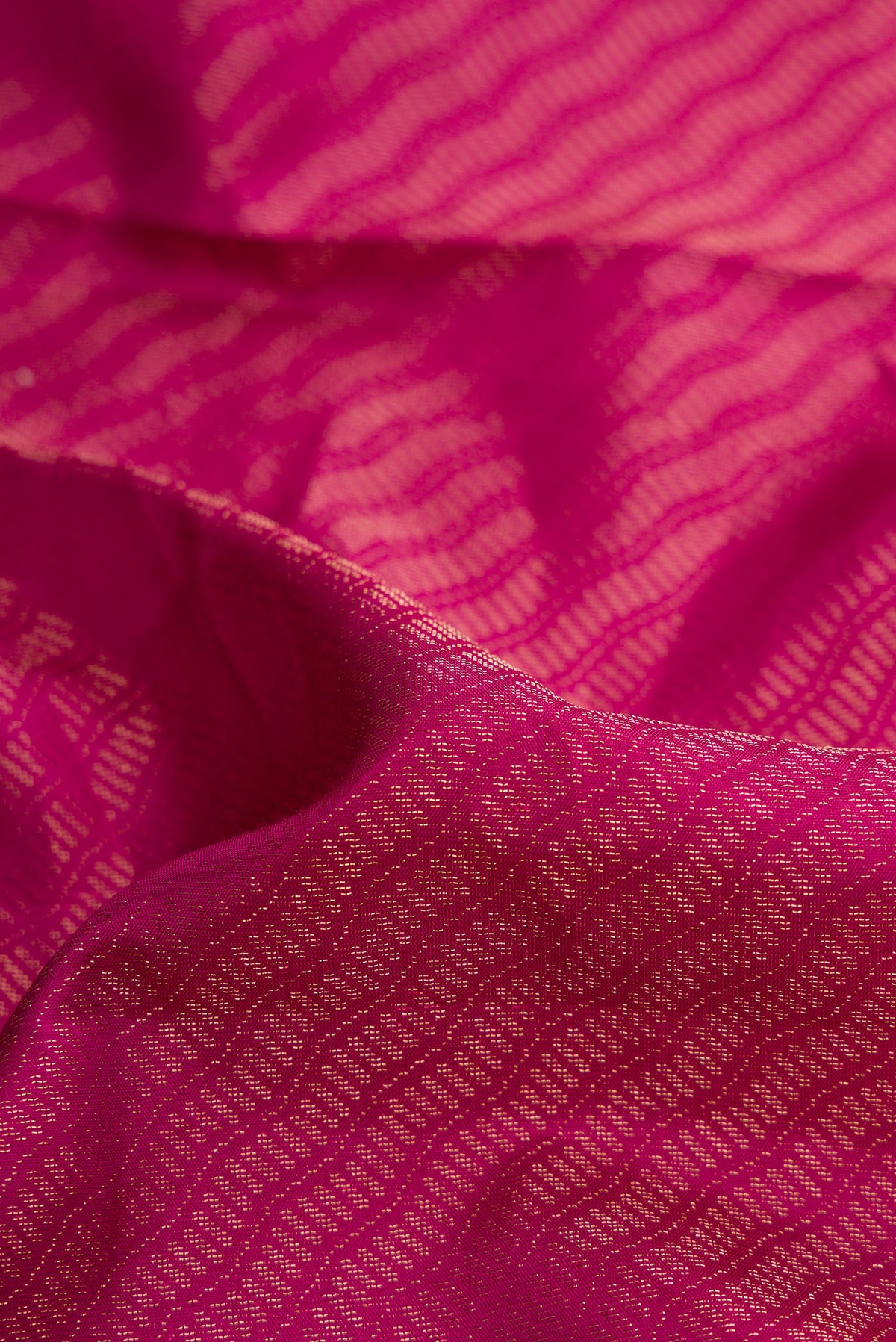 Close up of Magenta Dual Tone Soft Silk Saree with Zari Brocade on the body and Fancy Border.  displaying folds