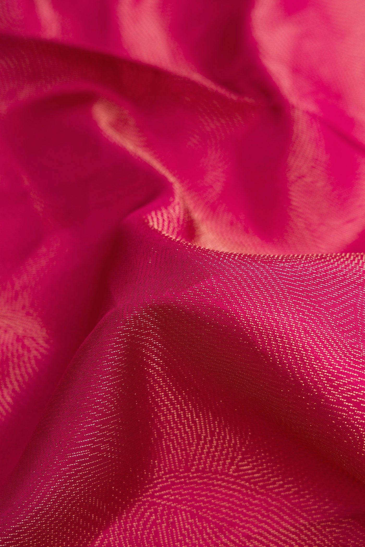 Close up of Magenta Dual Tone Soft Silk Saree with Zari Brocade on the body and Fancy Border.  displaying folds
