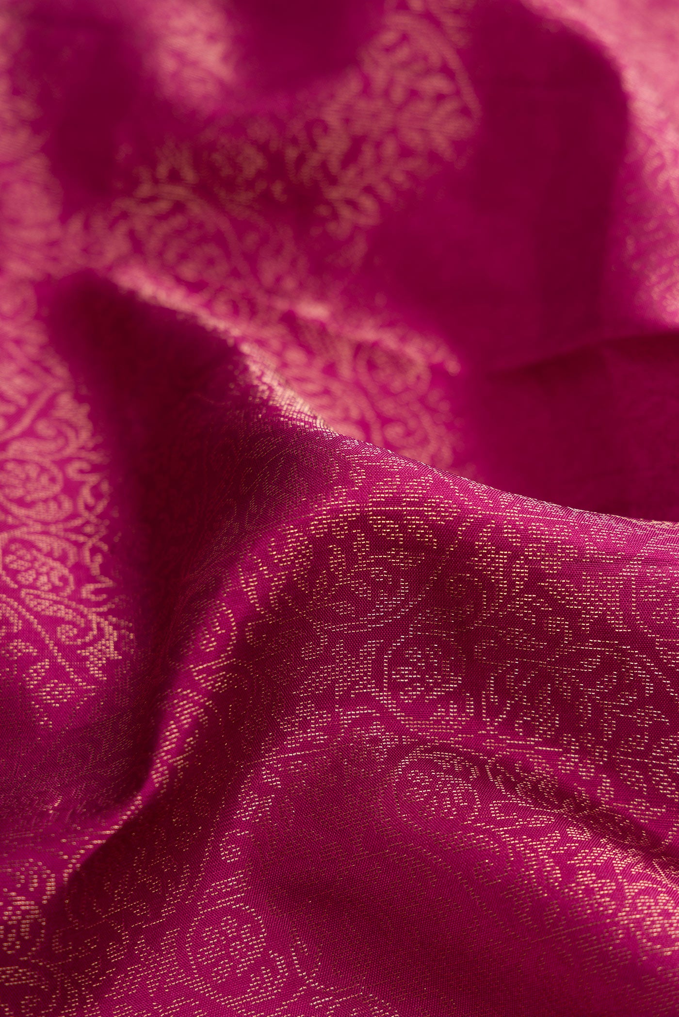 Close up of Dark Pink Dual Tone Soft Silk Saree with Zari Brocade on the body and Fancy Border.  displaying folds