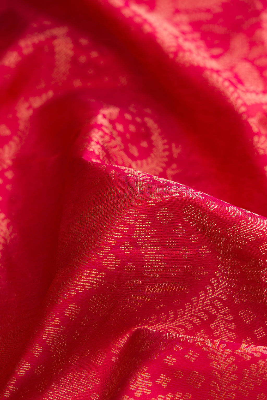 Close up of Brick Orange Dual Tone Soft Silk Saree with Zari Brocade on the body and Fancy Border.  displaying folds