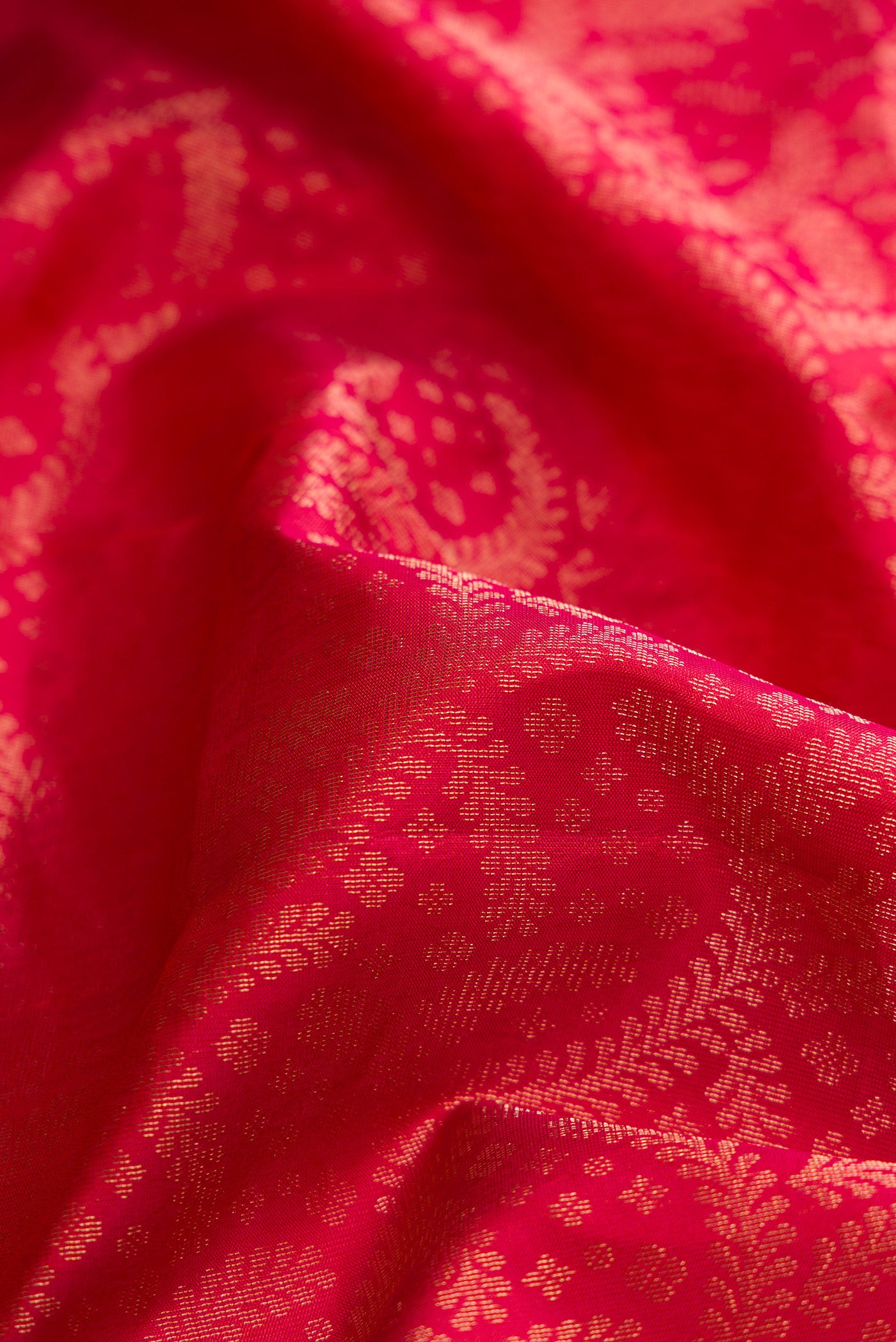 Close up of Brick Orange Dual Tone Soft Silk Saree with Zari Brocade on the body and Fancy Border.  displaying folds