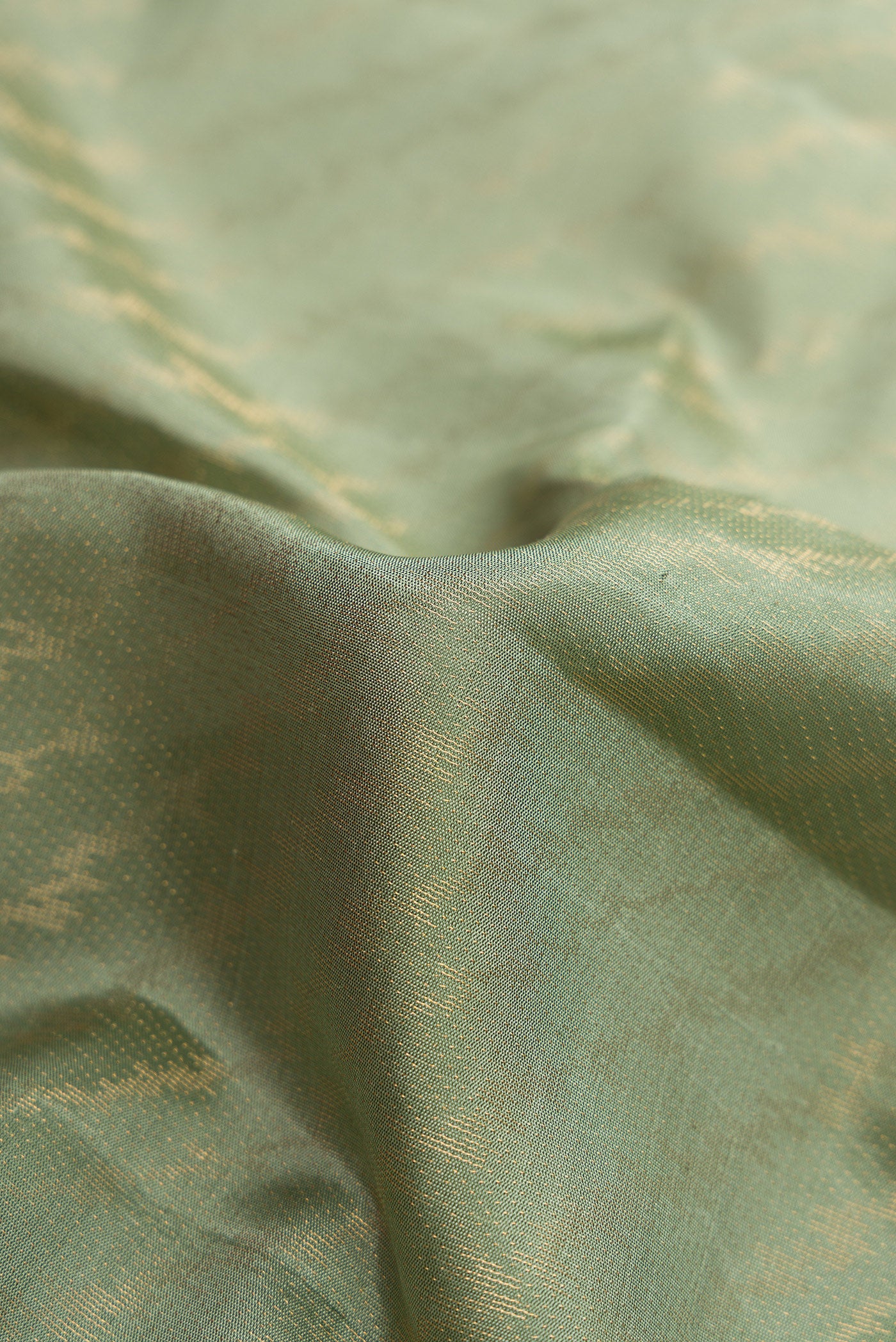 Close up of Pista Green Dual Tone Soft Silk Saree with Zari Brocade on the body and Fancy Border.  displaying folds