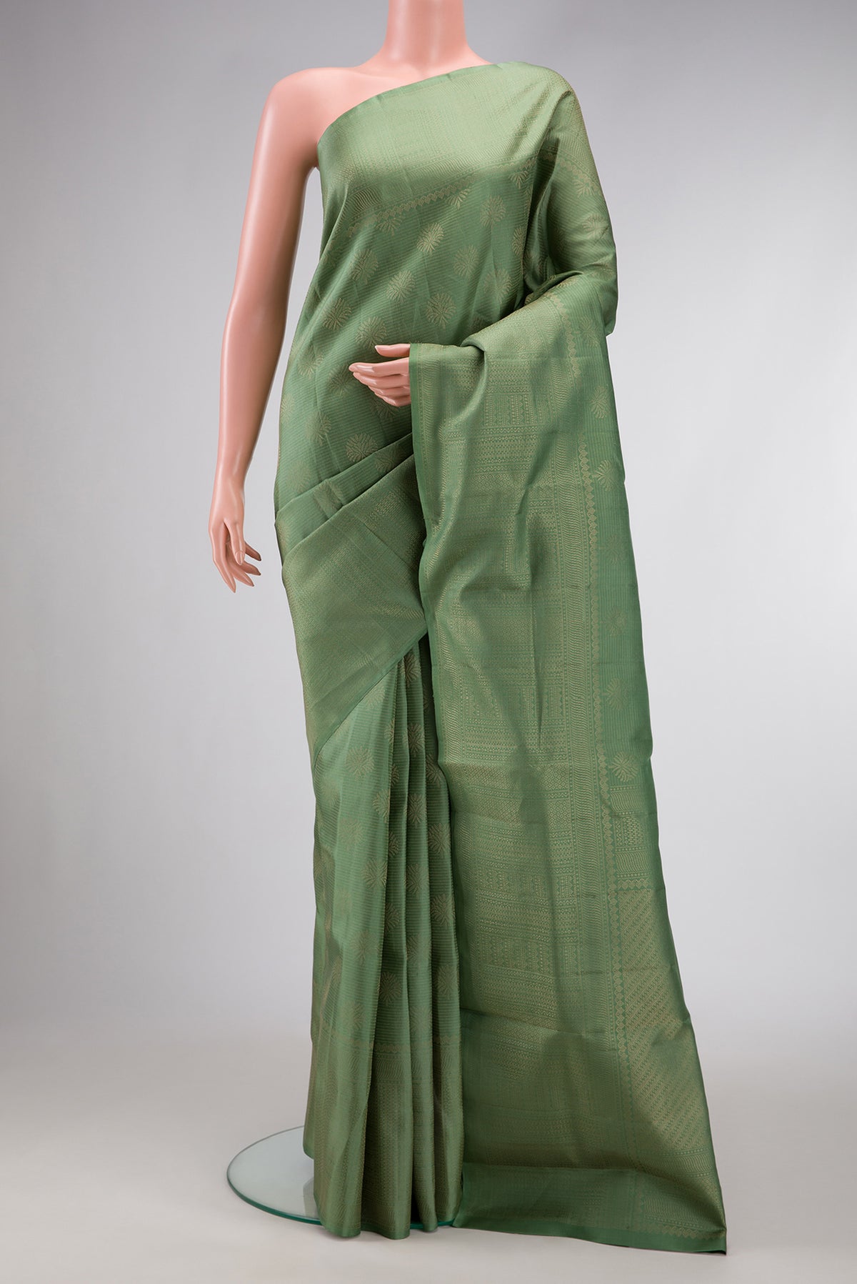 Pista Green Dual Tone Soft Silk Saree with Zari Brocade on the body and Fancy Border.  displayed on a mannequin