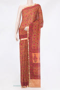 Orange Crepe Saree with Printed design on the body and Zari Border.  displayed on a mannequin