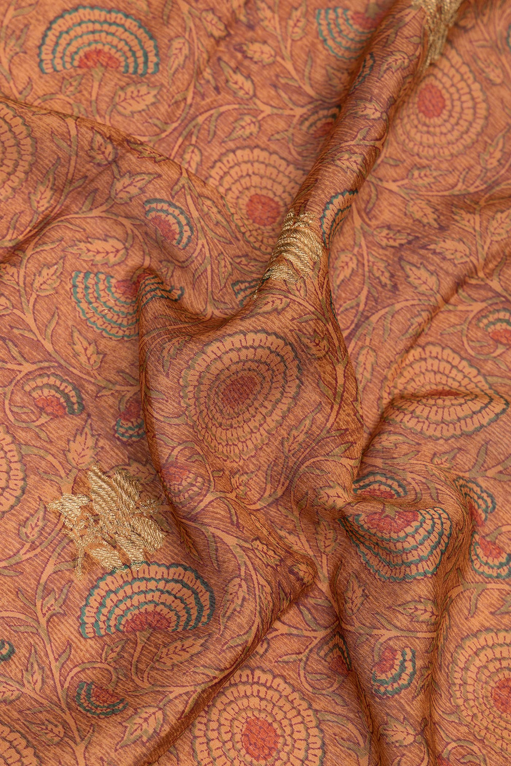 Close up of Brown Crepe Saree with Printed design on the body and Zari Border.  displaying folds