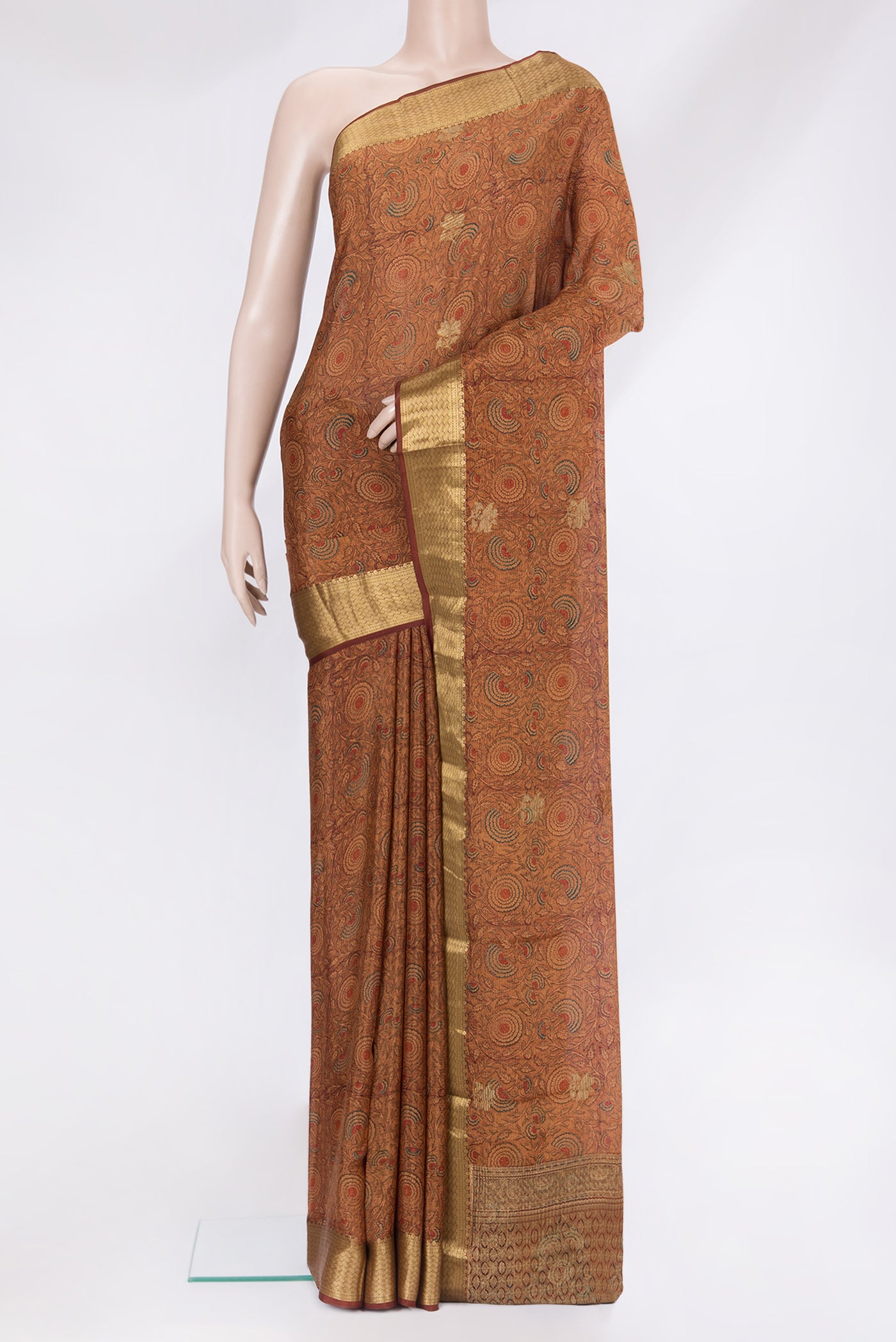 Brown Crepe Saree with Printed design on the body and Zari Border.  displayed on a mannequin