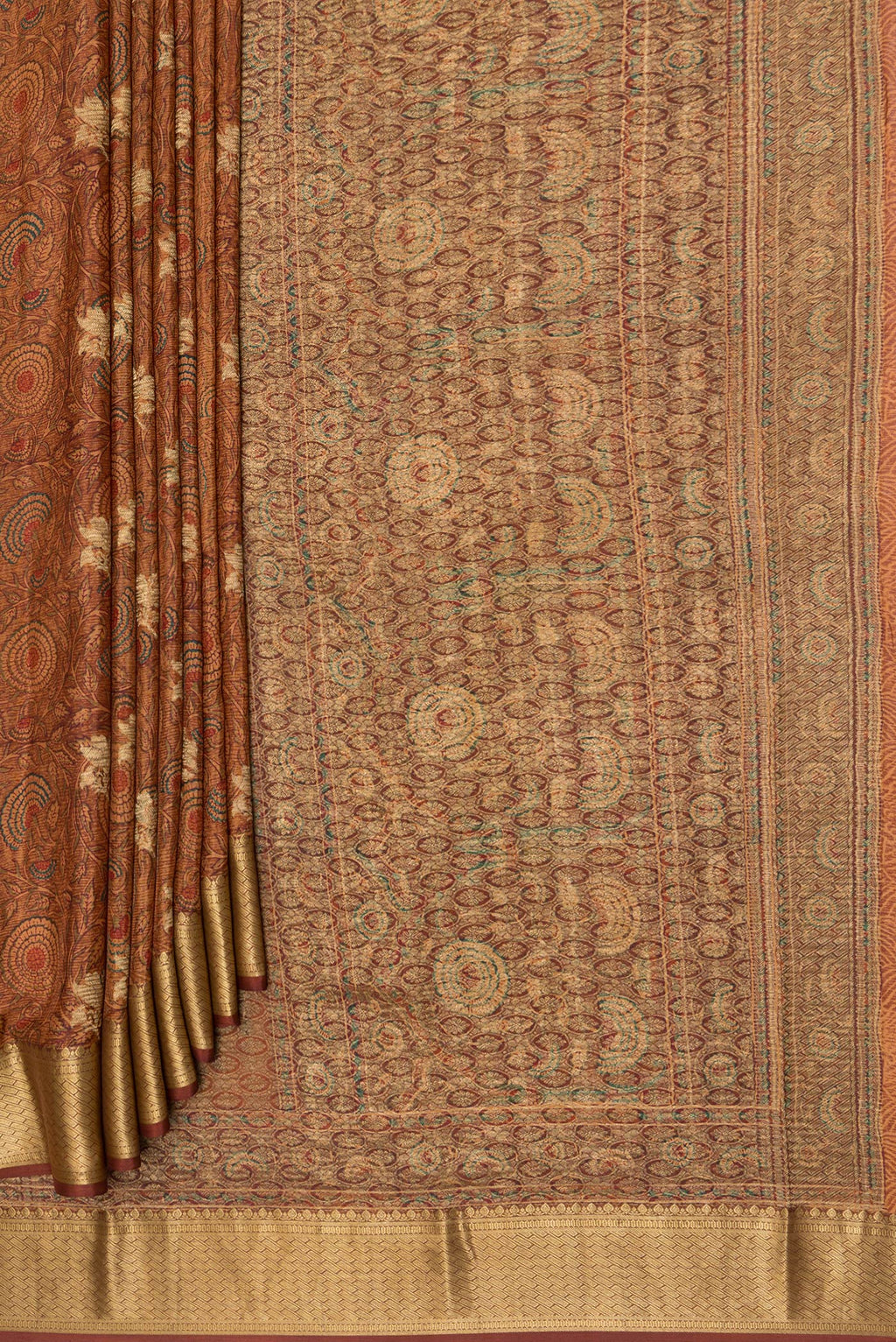 Pleats and pallu of Brown Crepe Saree with Printed design on the body and Zari Border. 