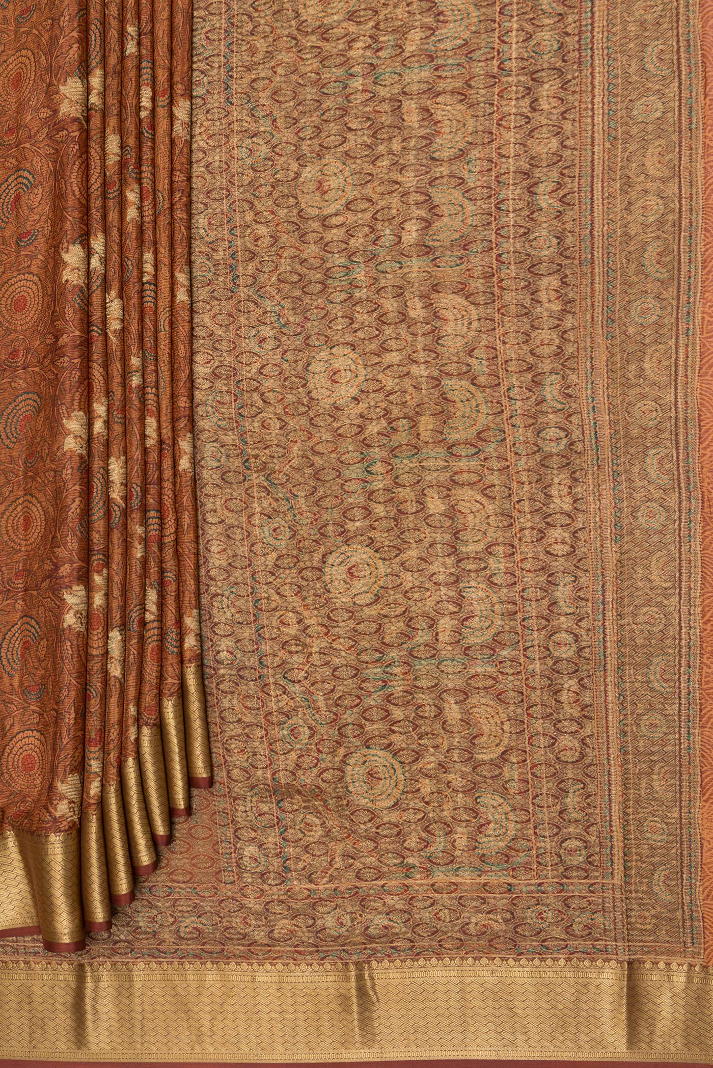 Pleats and pallu of Brown Crepe Saree with Printed design on the body and Zari Border. 