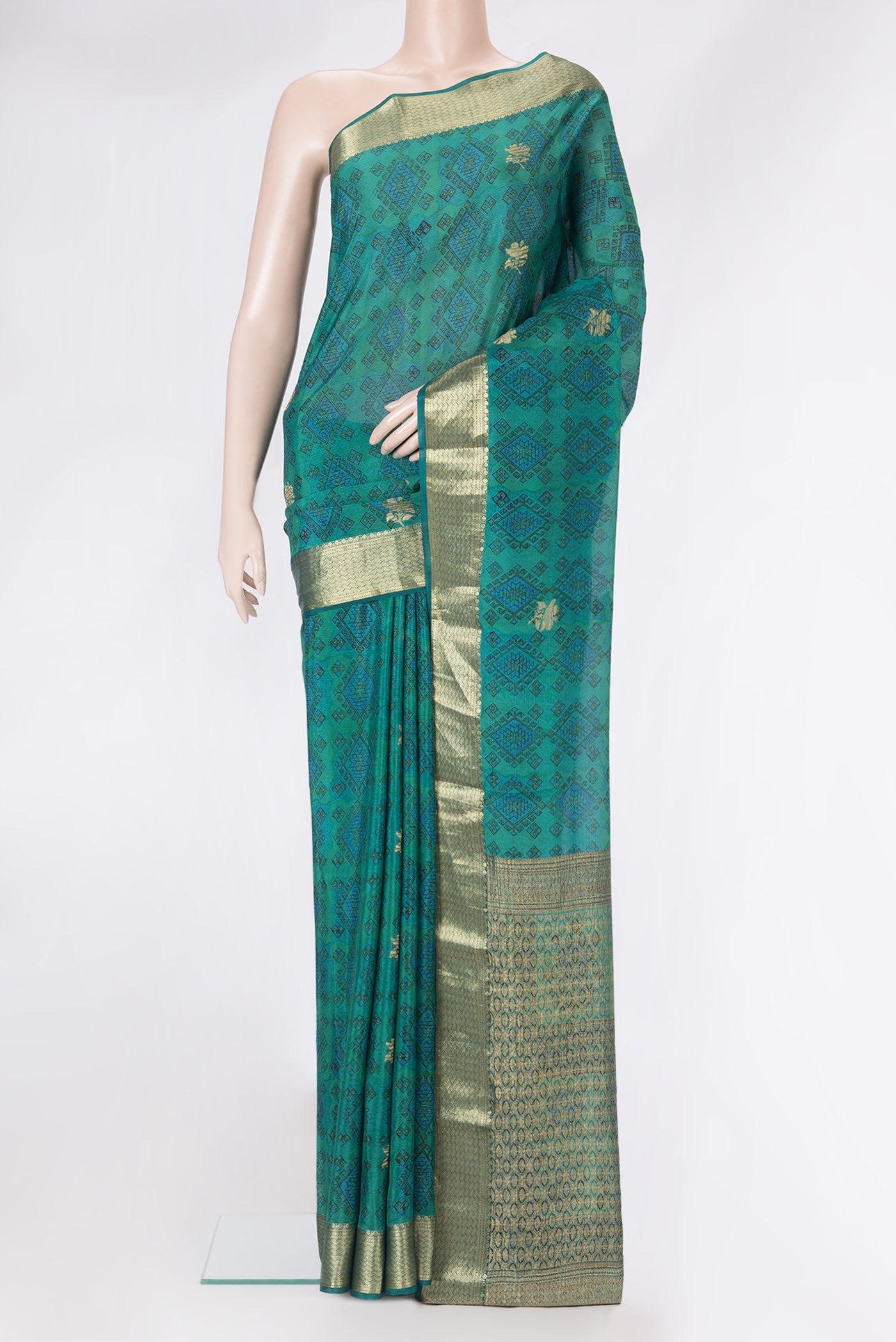 Peacock Blue Dual Tone Crepe Saree with Printed design on the body and Zari Border.  displayed on a mannequin