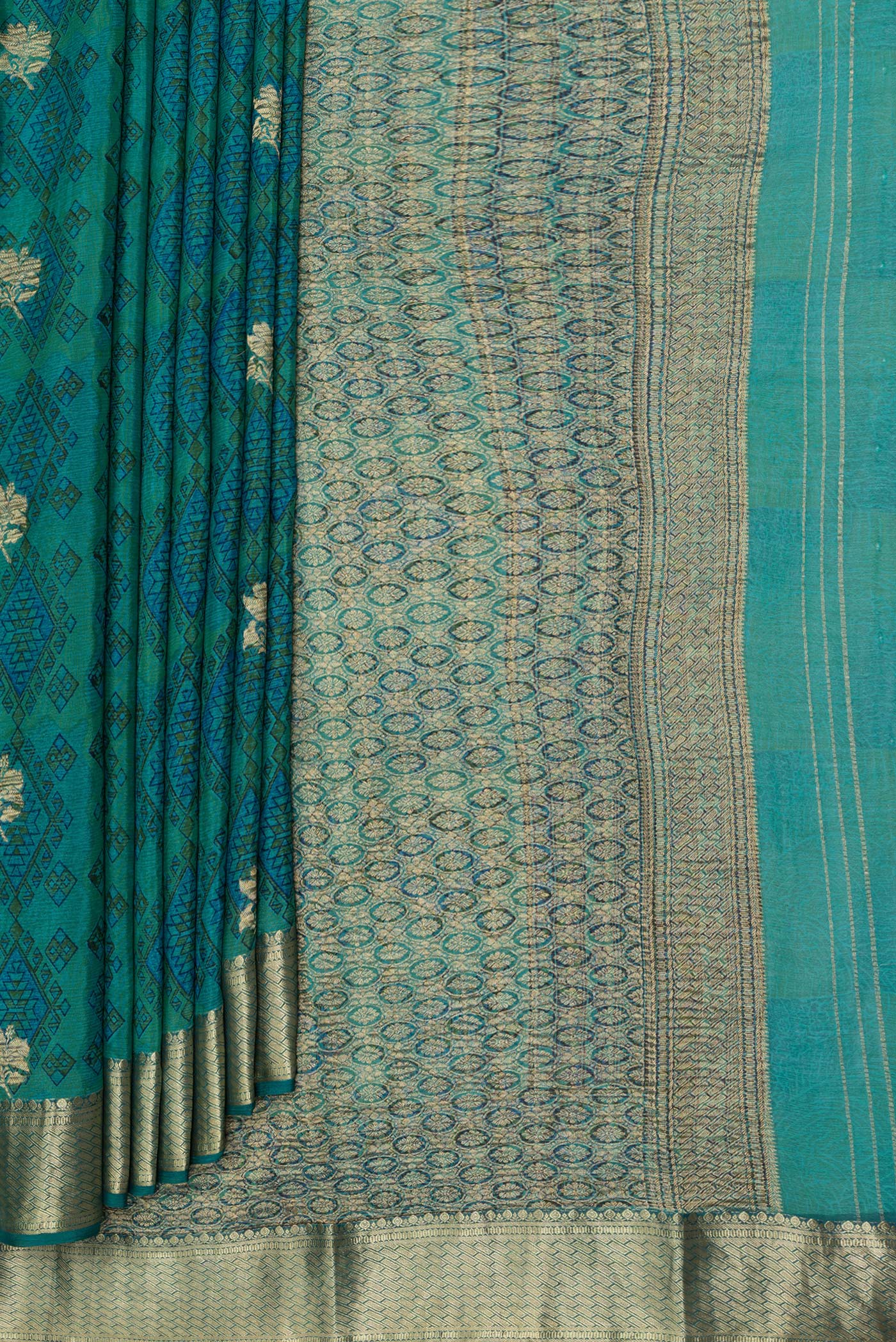 Pleats and pallu of Peacock Blue Dual Tone Crepe Saree with Printed design on the body and Zari Border. 