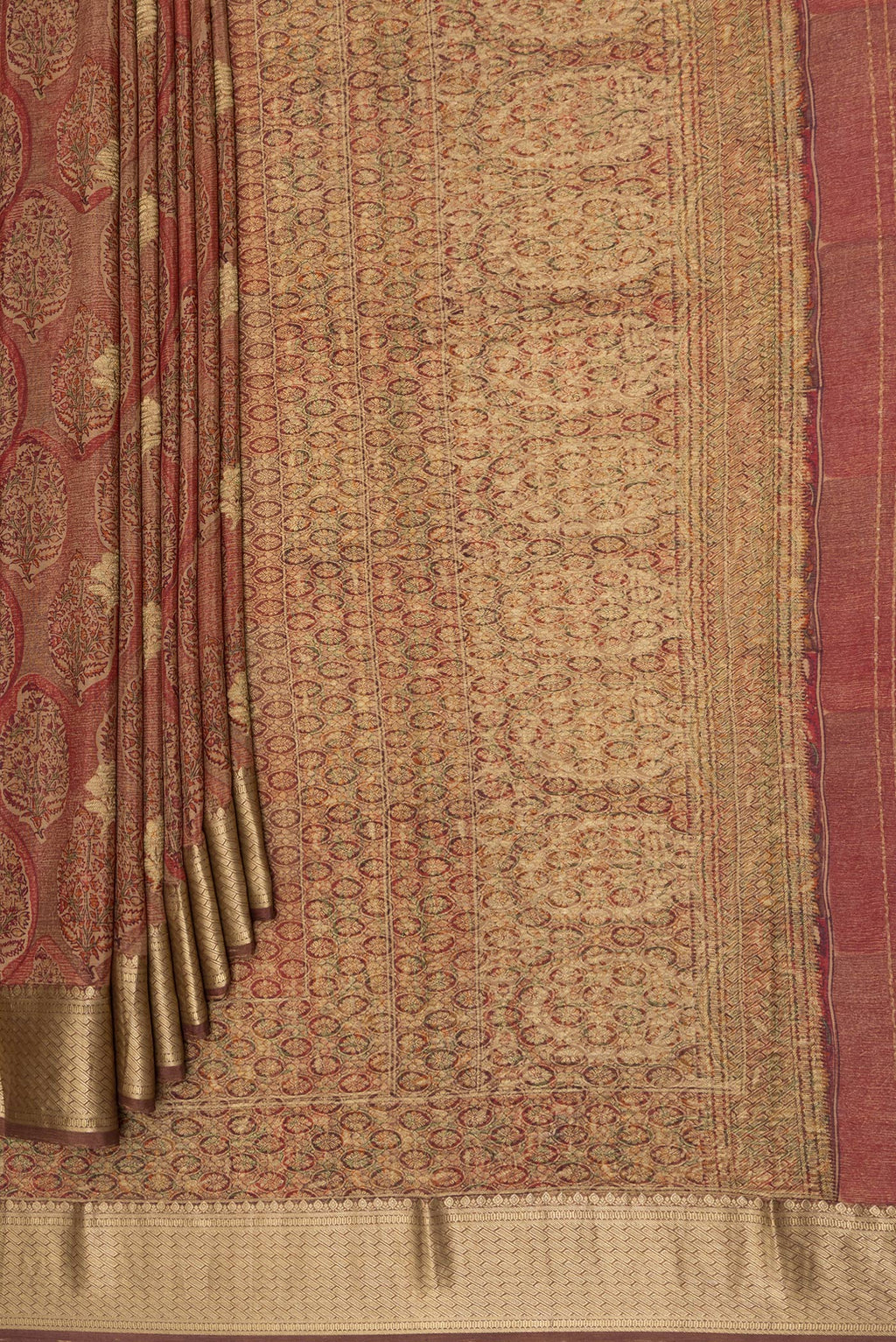Pleats and pallu of Brown Crepe Saree with Printed design on the body and Zari Border. 