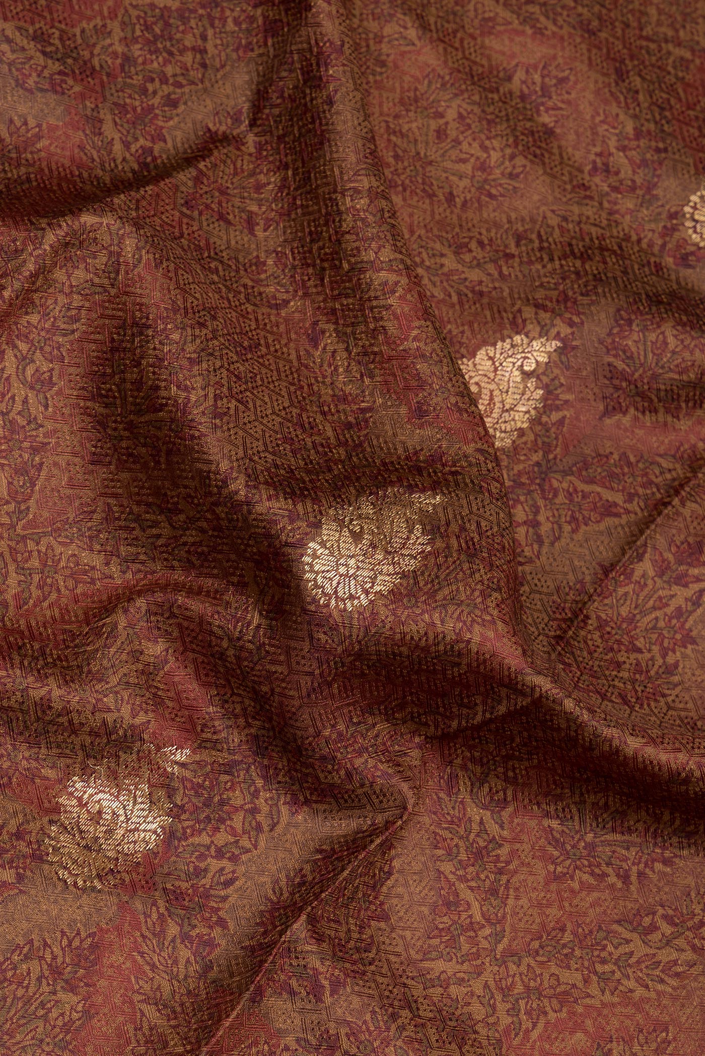 Close up of Brown Kanchipuram Silk Saree with Printed design on the body and Zari Border.  displaying folds