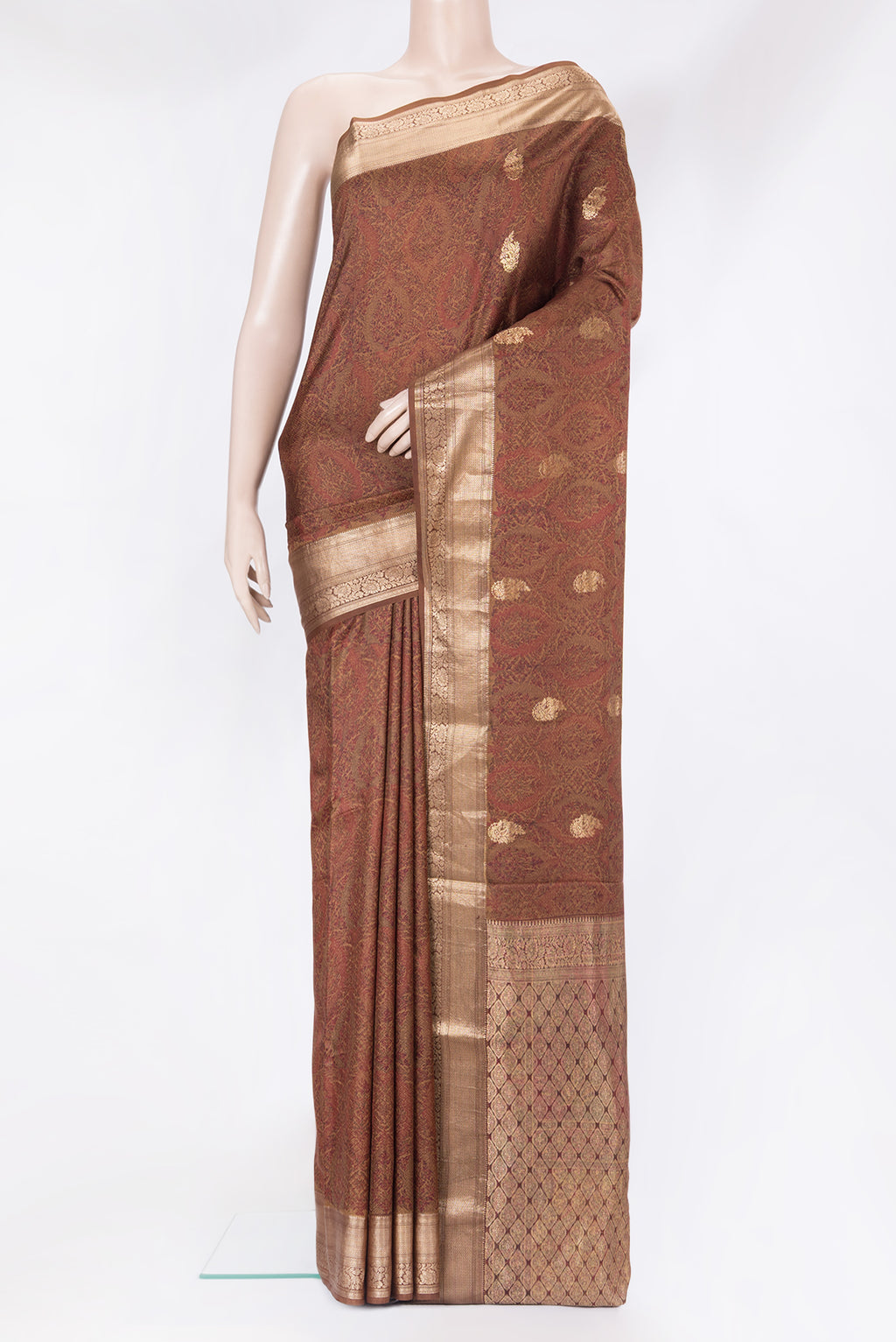 Brown Kanchipuram Silk Saree with Printed design on the body and Zari Border.  displayed on a mannequin