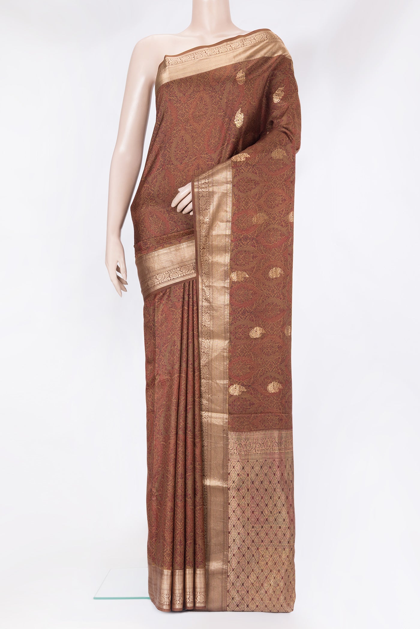 Brown Kanchipuram Silk Saree with Printed design on the body and Zari Border.  displayed on a mannequin