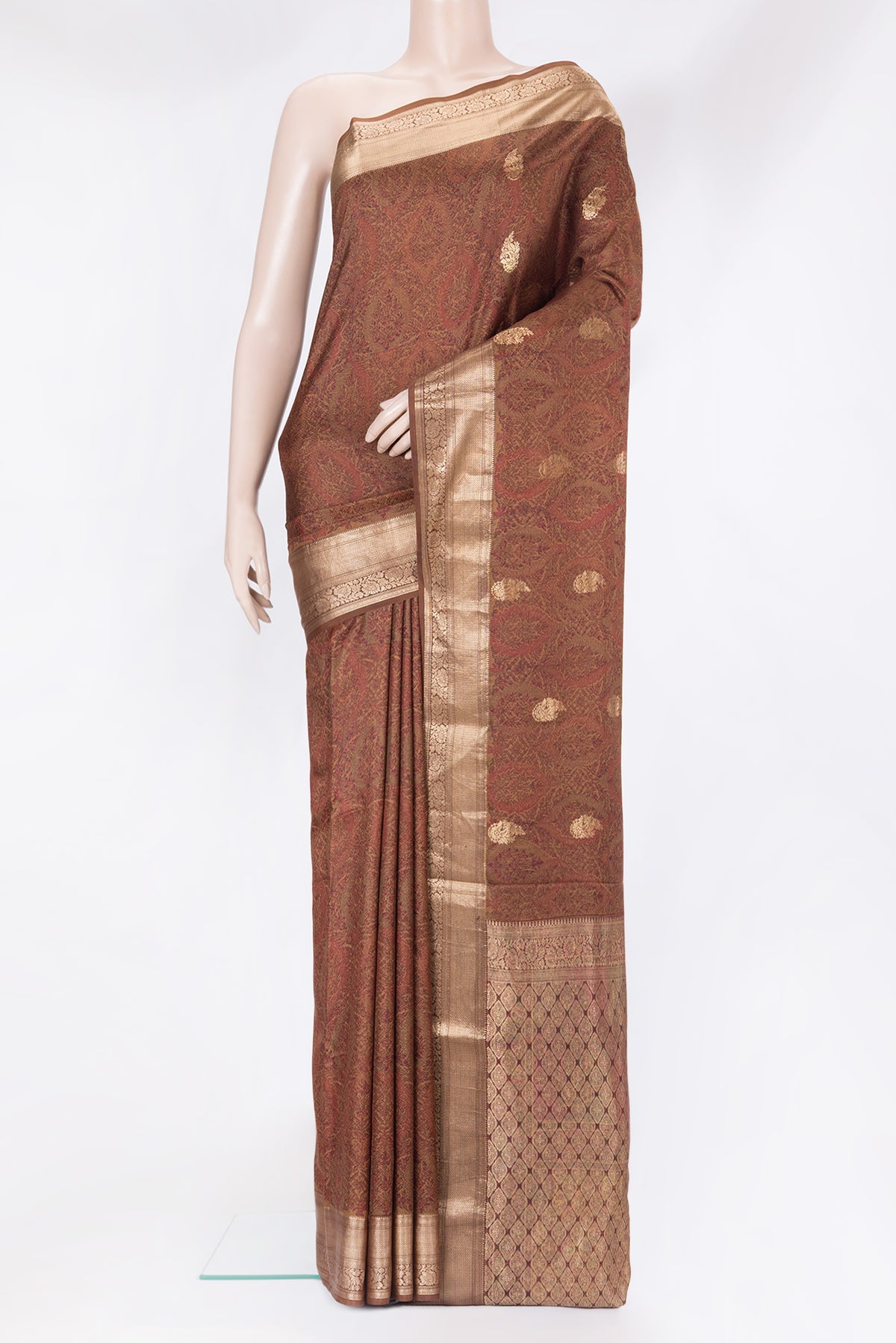 Brown Kanchipuram Silk Saree with Printed design on the body and Zari Border.  displayed on a mannequin