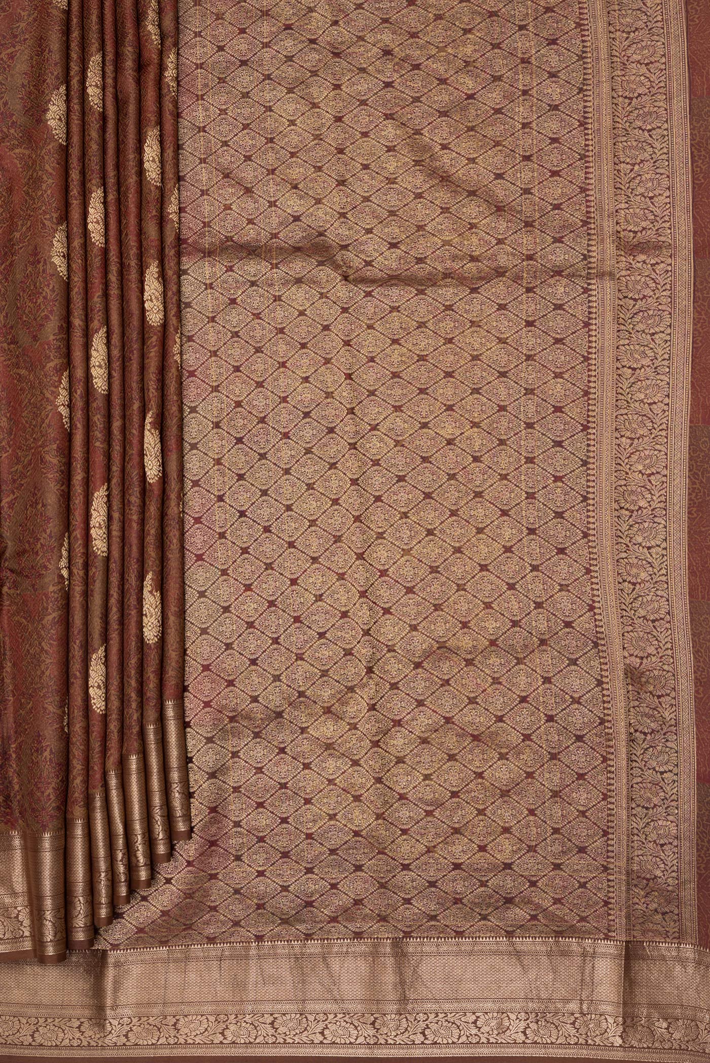 Pleats and pallu of Brown Kanchipuram Silk Saree with Printed design on the body and Zari Border. 